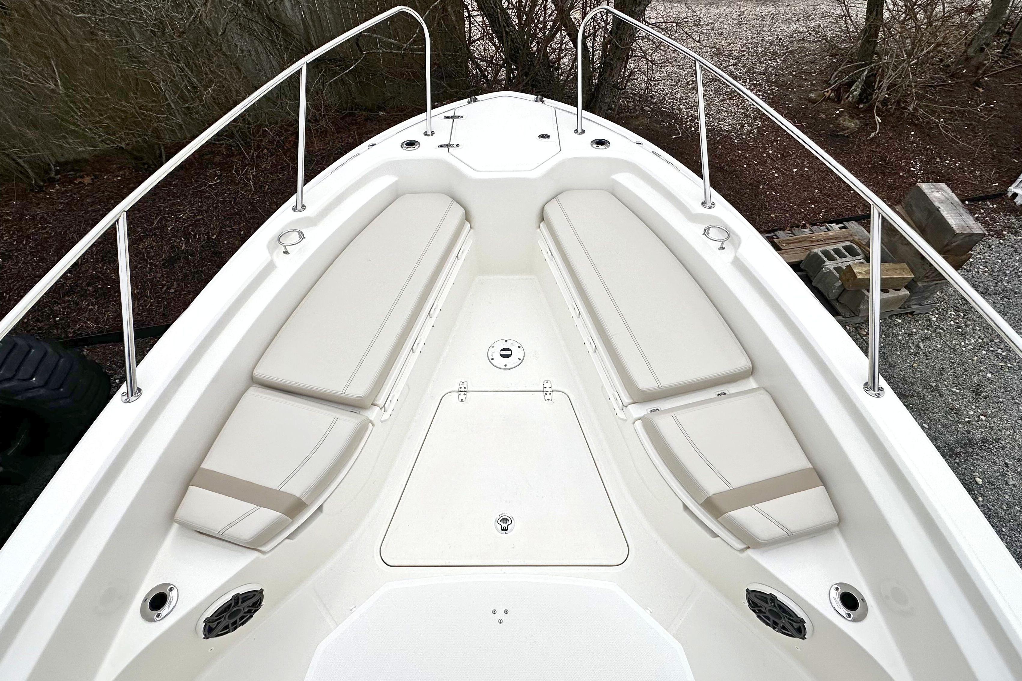 2026 Boston Whaler 280 Dauntless boat bow with cushioned seating and stainless steel railings.