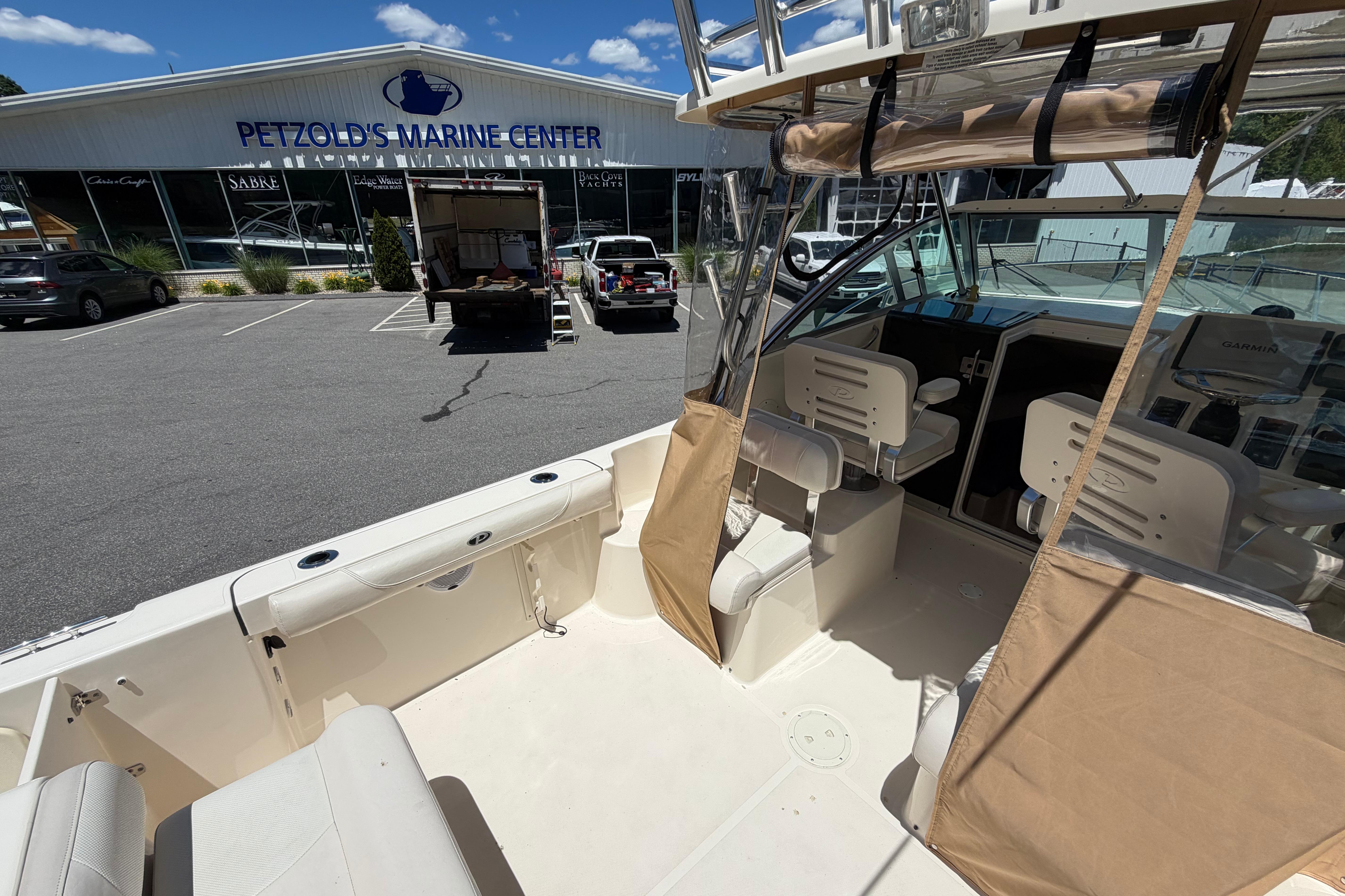 2010 Pursuit OS 255 Offshore boat at Petzold's Marine Center parking lot.