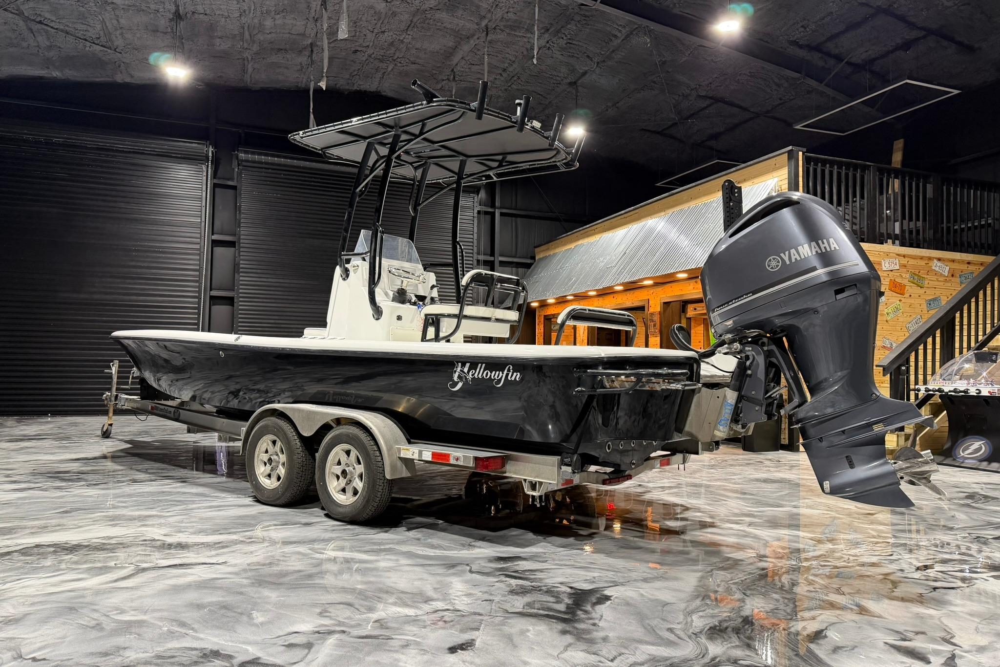 2011 Yellowfin 24 Bay boat with Yamaha engine on trailer in showroom.
