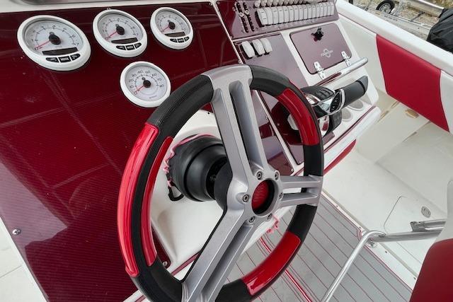 Steering wheel and gauges of 2001 Fountain 38 Center Console boat.