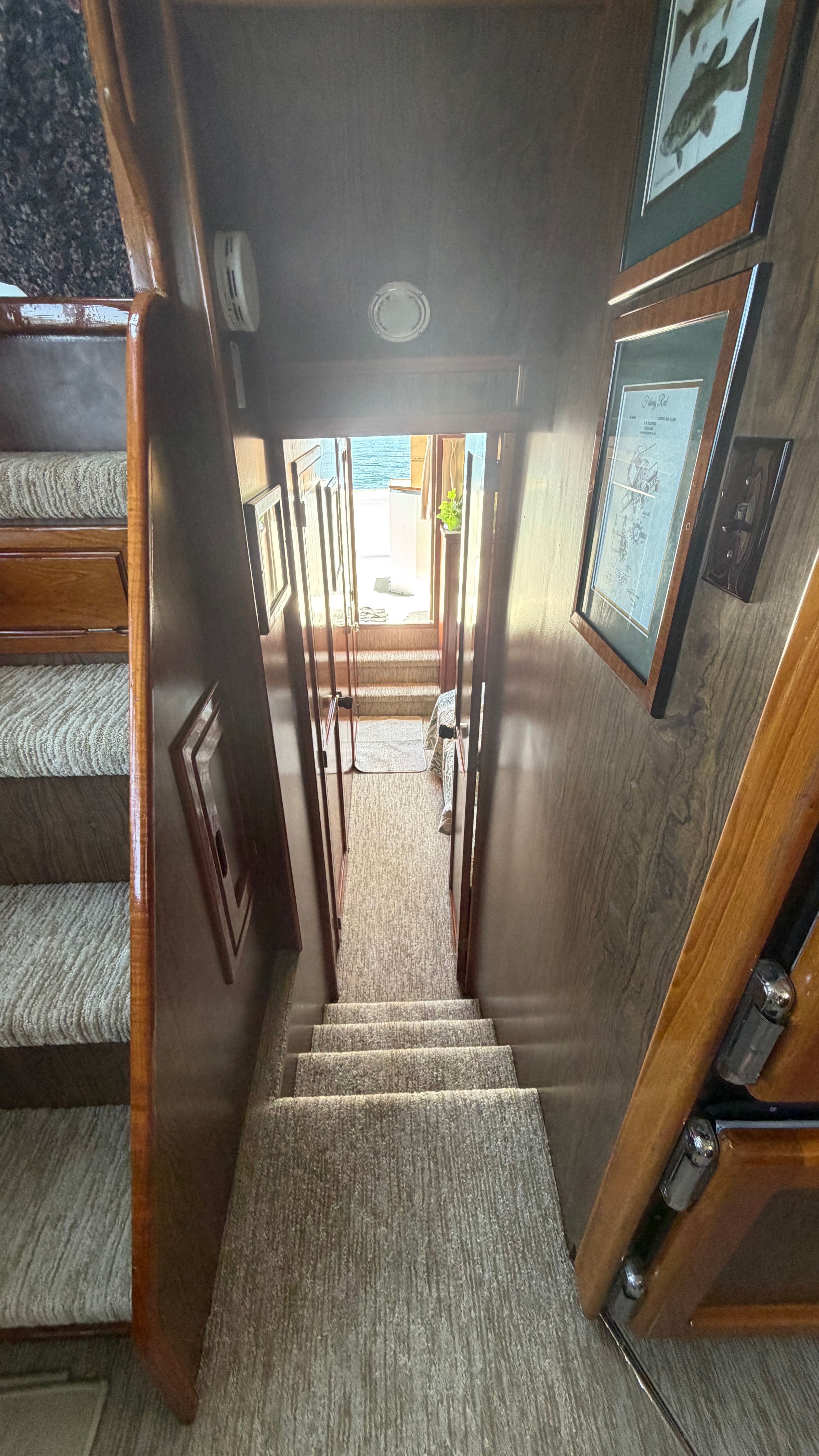 Interior of a 1966 Drake Yachtfisher with stairs and wooden walls.