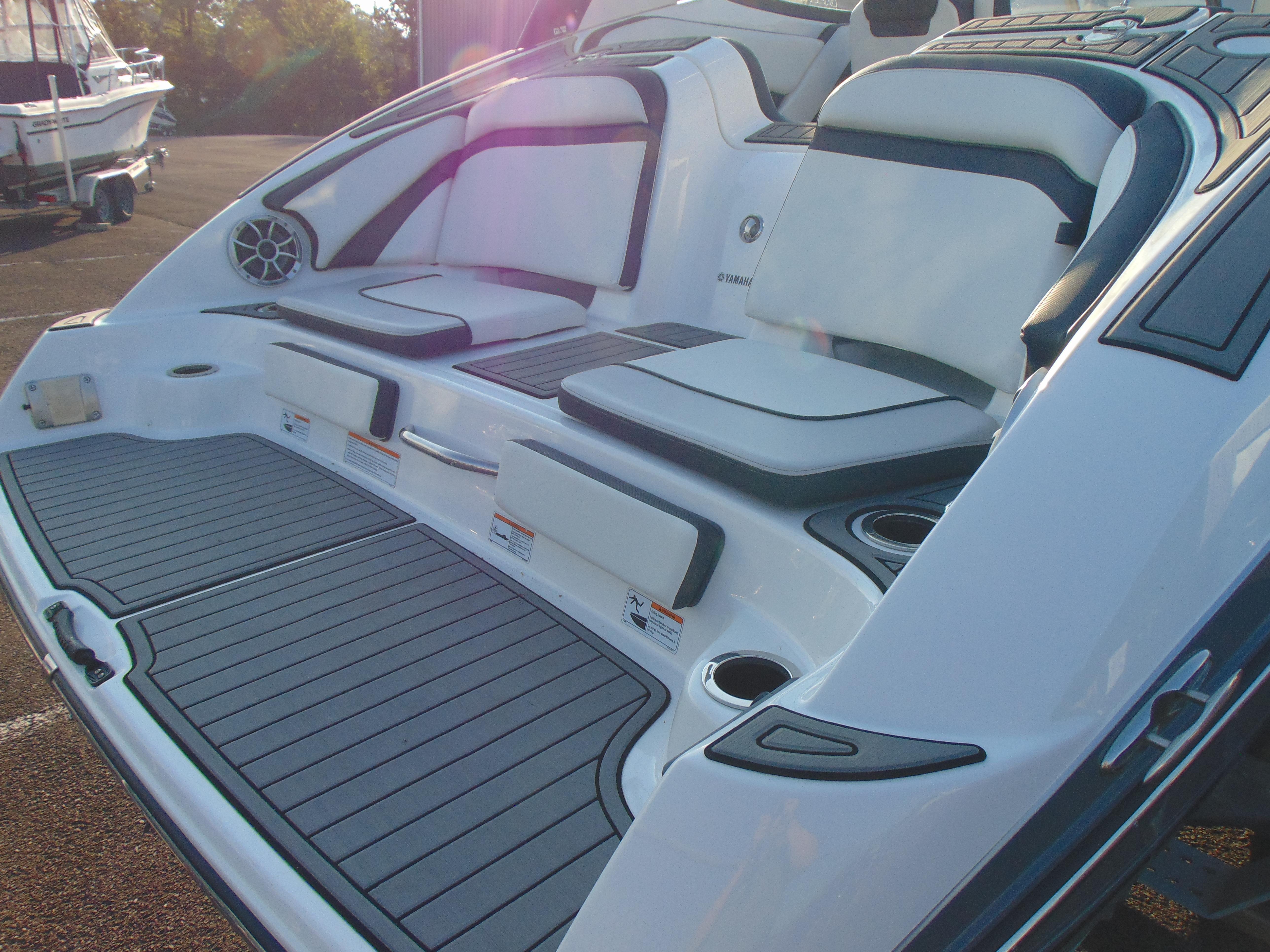 2019 Yamaha Boats 242 Limited S E-Series, rear seating and deck area, sunlight reflection.