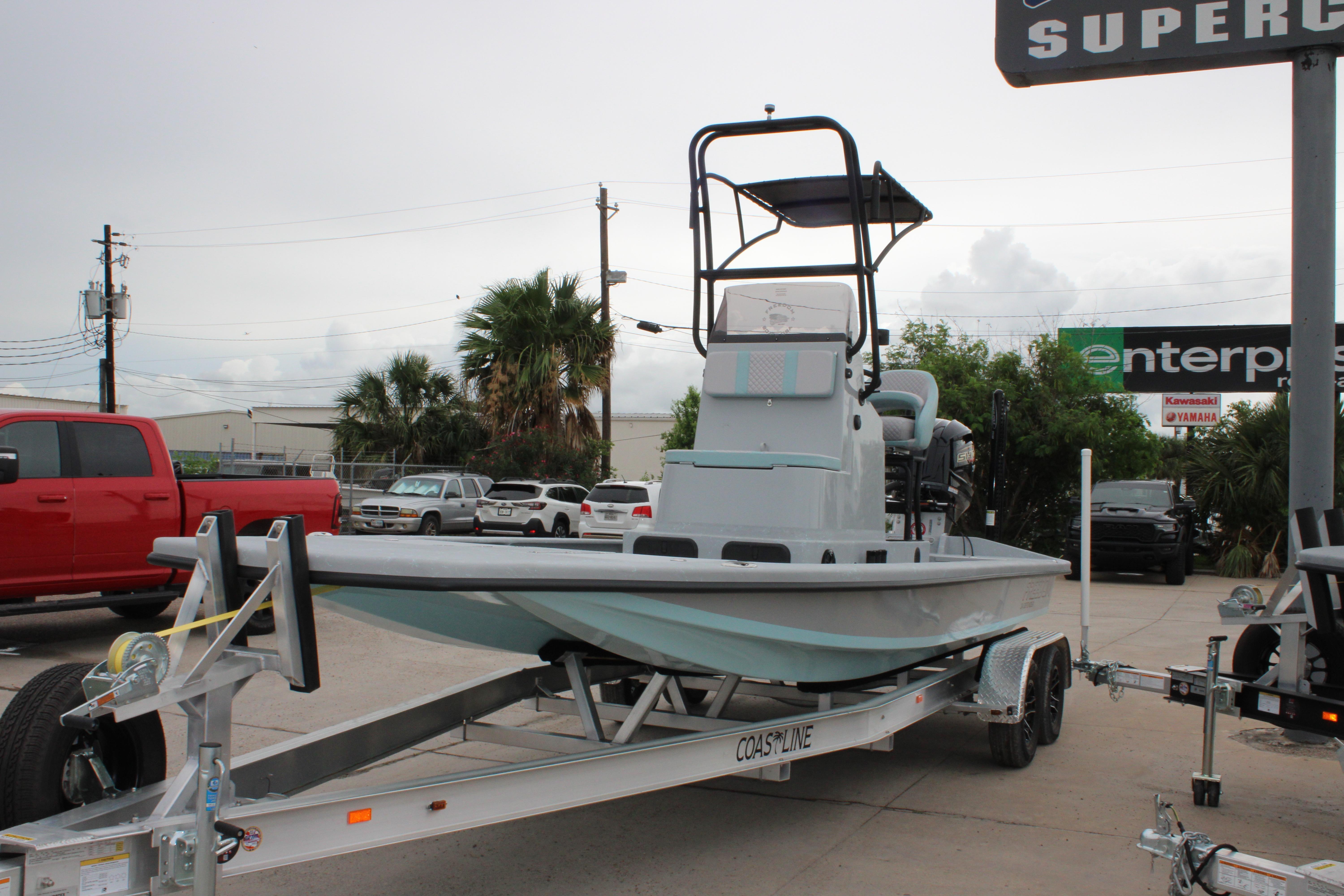 2026 Freedom Boats 24 Defender on trailer in outdoor dealership setting.