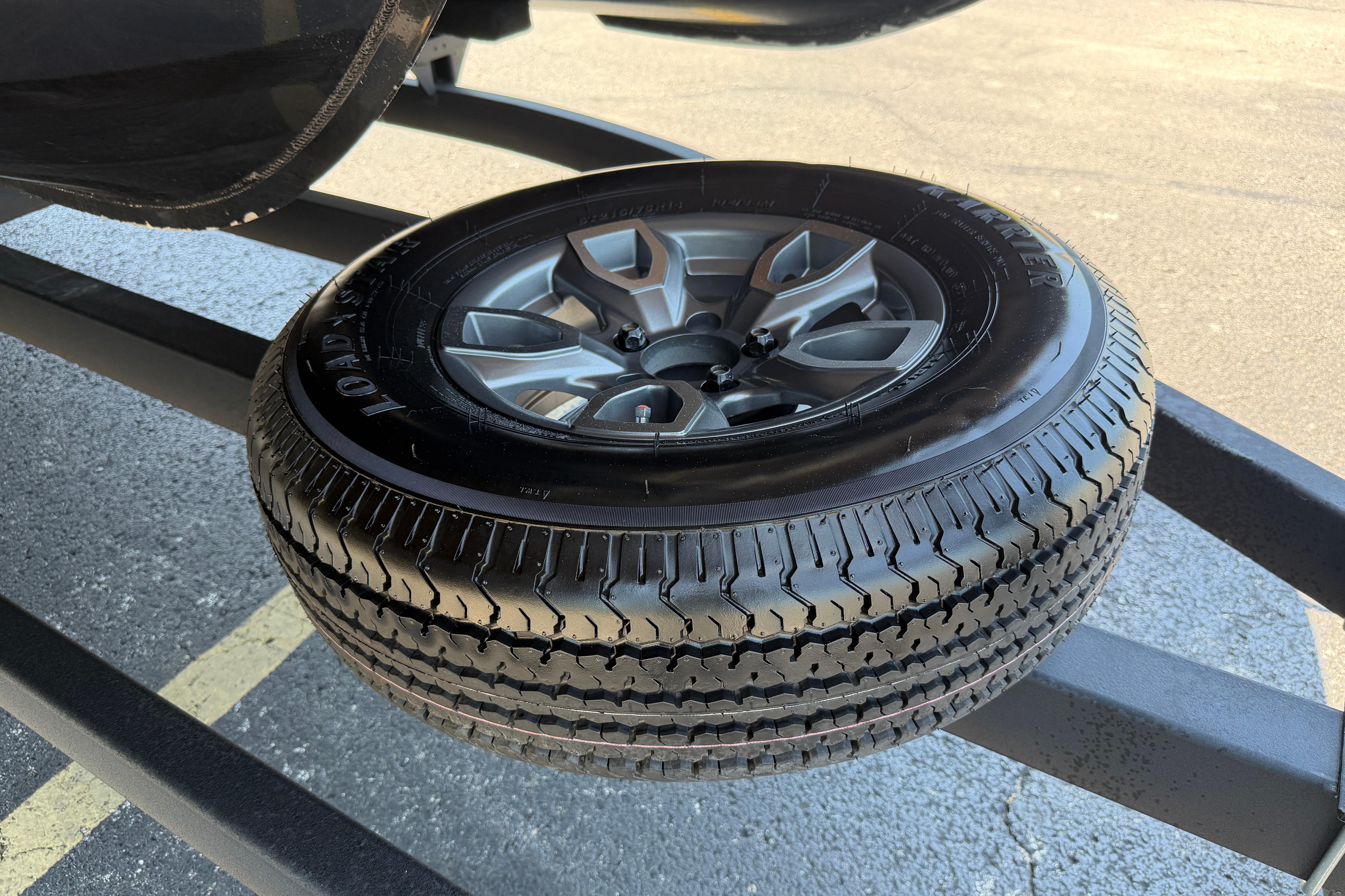 2024 Regency R250DL3 spare tire mounted on a trailer, showcasing tread and alloy wheel design.