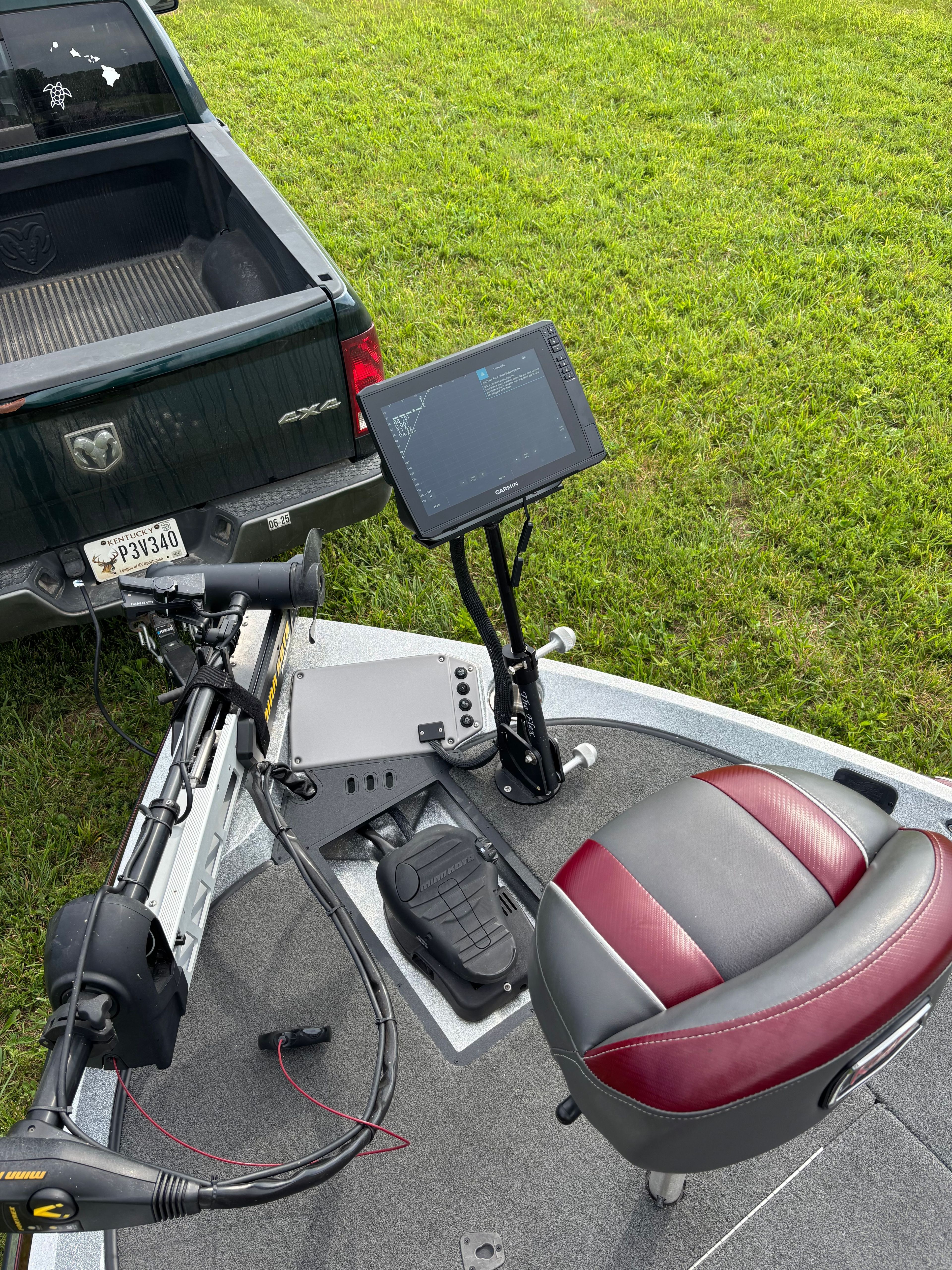 A Ranger Z 185 boat with a seat and screen, on a trailer next to a truck.