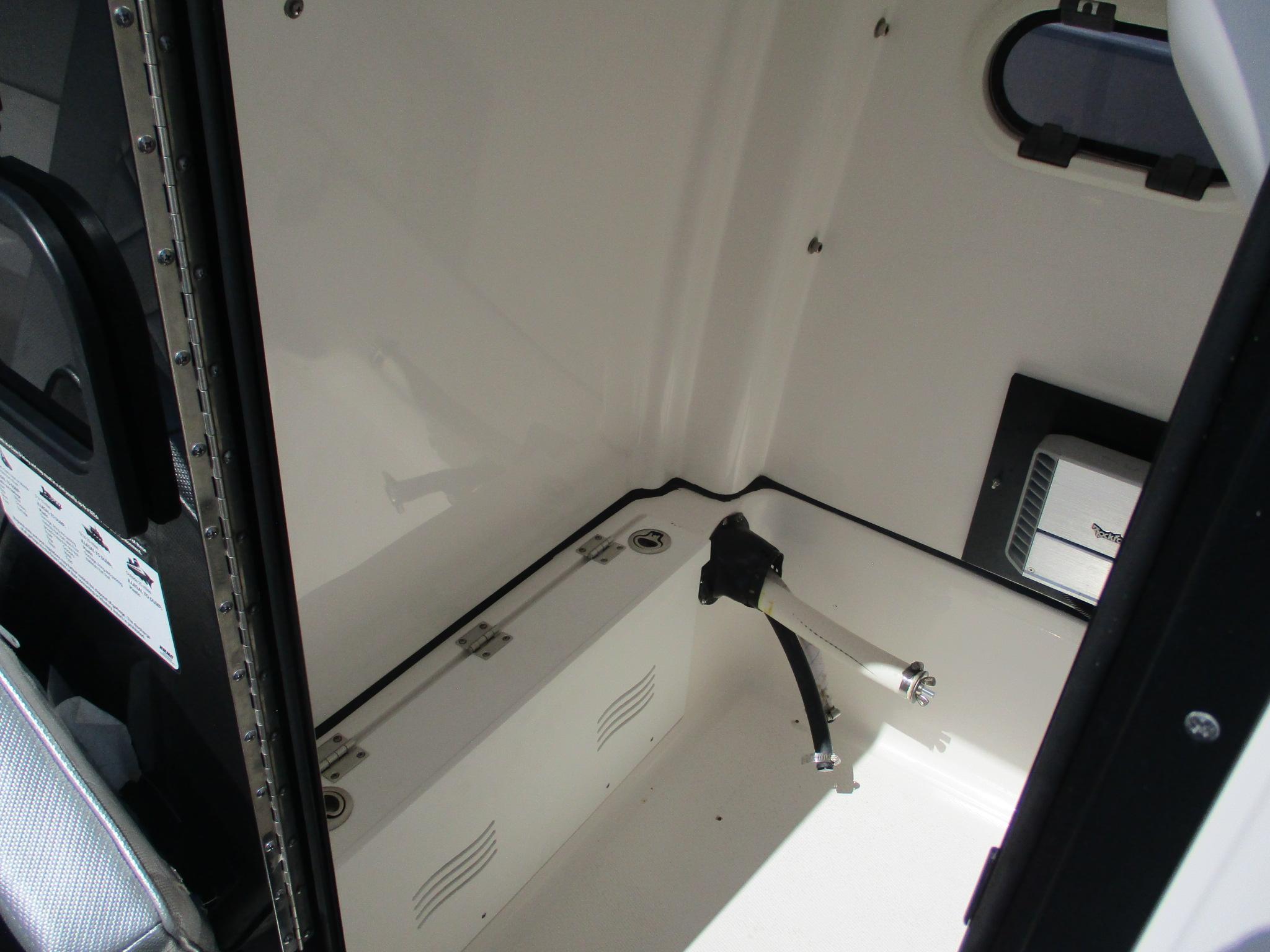 2024 Blue Wave 2800 Makaira boat interior, featuring storage compartment and sleek design.