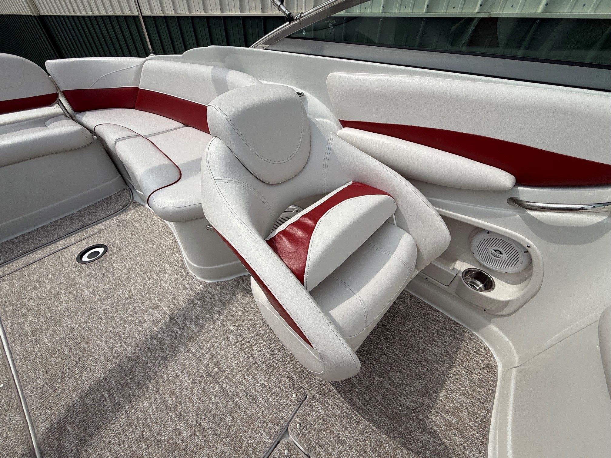 Interior of a 2012 Crownline 252 EX boat with white and red seating.