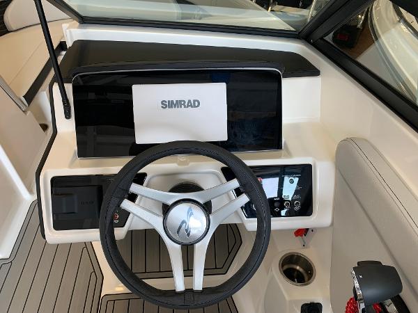 2025 Sea Ray SPX 230 boat dashboard with Simrad display and steering wheel.