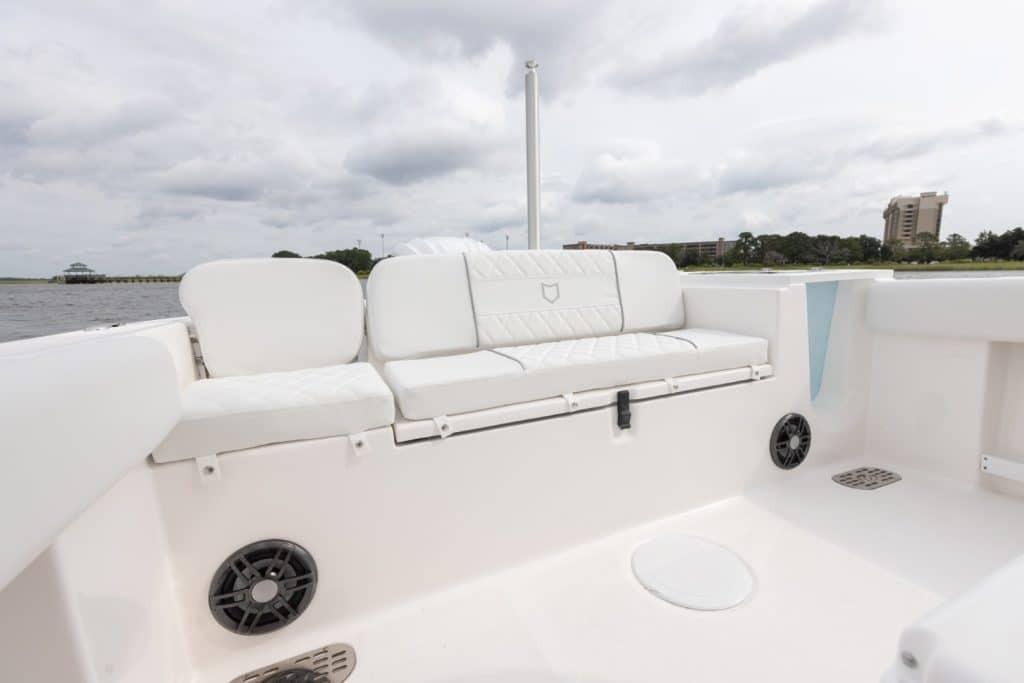 2027 Sea Fox 248 Commander boat interior with white seating and speakers.