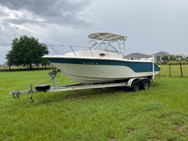 2008 Sea Fox 236WA Pro Series boat on a trailer in a grassy field.