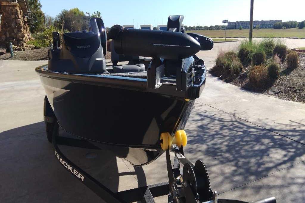 2026 Tracker Super Guide V-16 SC boat on trailer, parked outdoors.