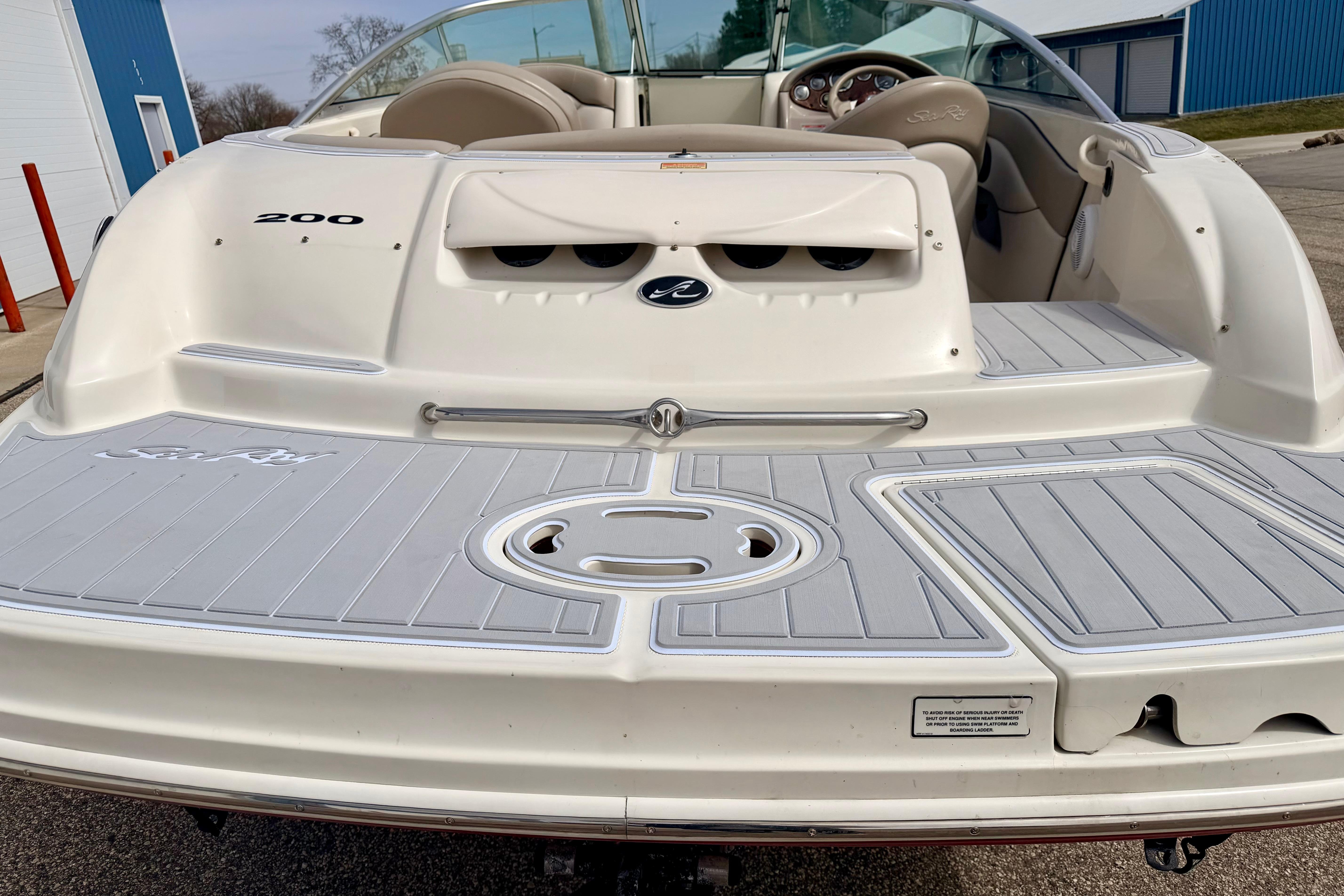 2003 Sea Ray 200 Sundeck boat, rear view, showcasing spacious deck and seating area.