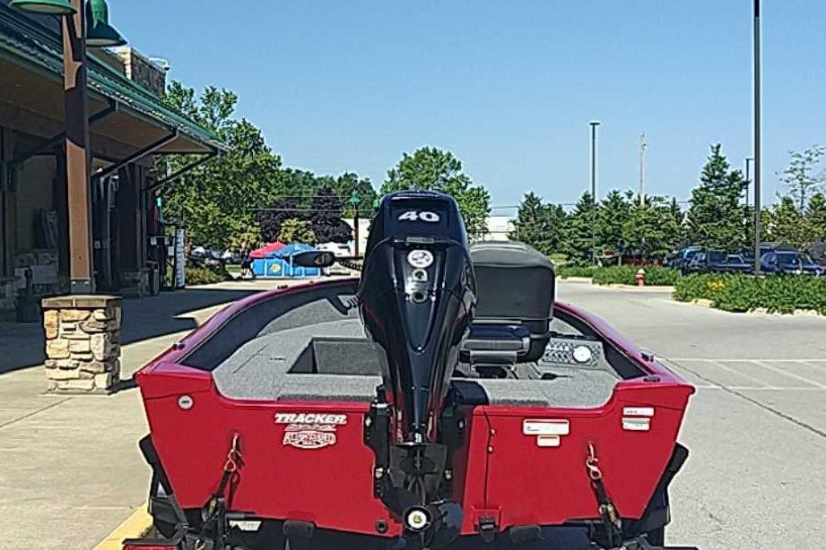 2026 Tracker Super Guide V-16 T boat with 40 HP motor, parked outdoors.