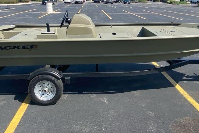 2026 Tracker Grizzly 1648 SC boat on trailer in parking lot.