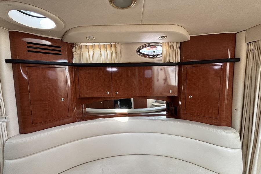 Interior of 2002 Sea Ray Sundancer 320 with wood cabinetry and porthole window.