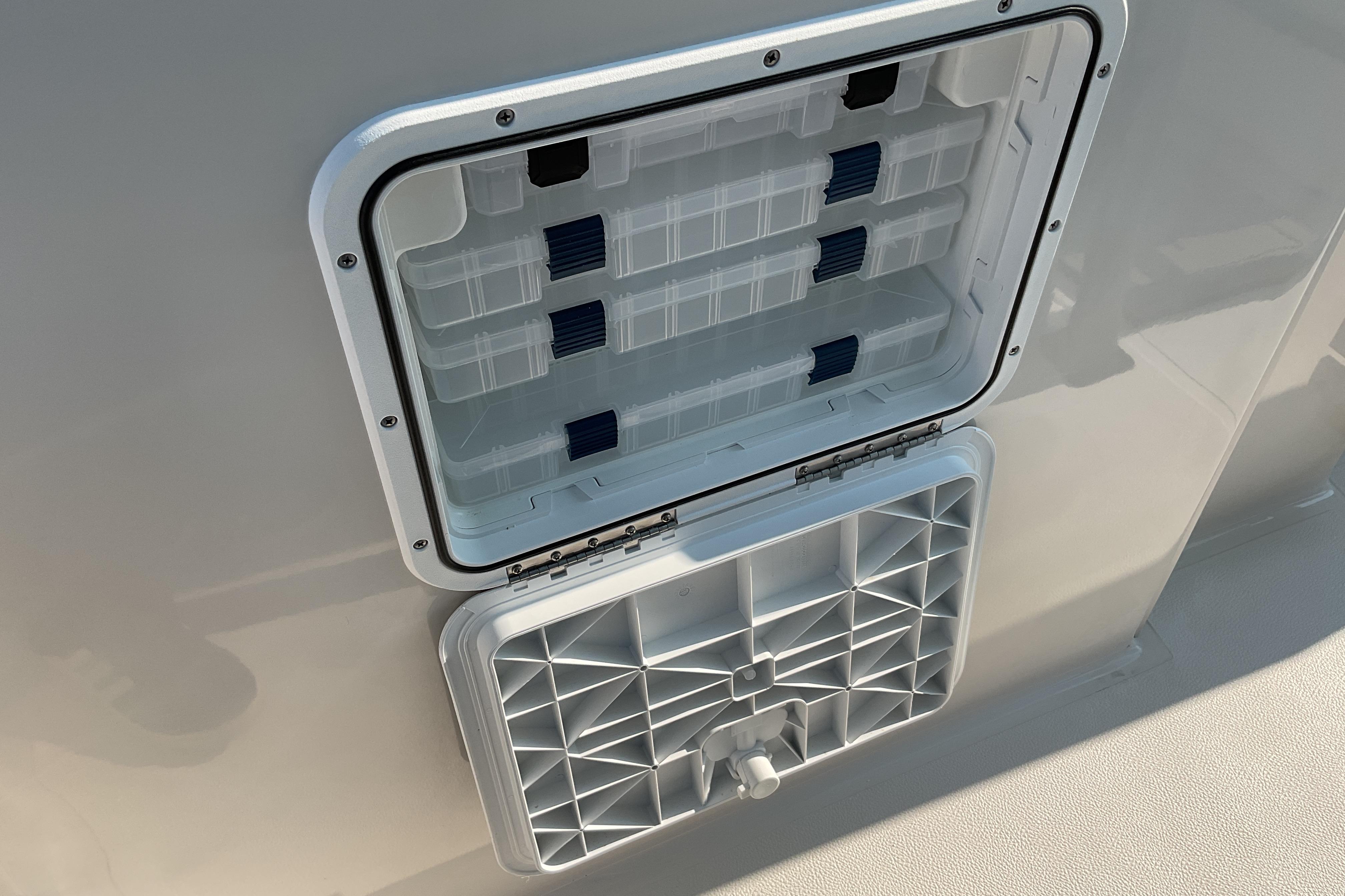 Open storage compartment on 2026 Starcraft SVX 231 OB CC boat.