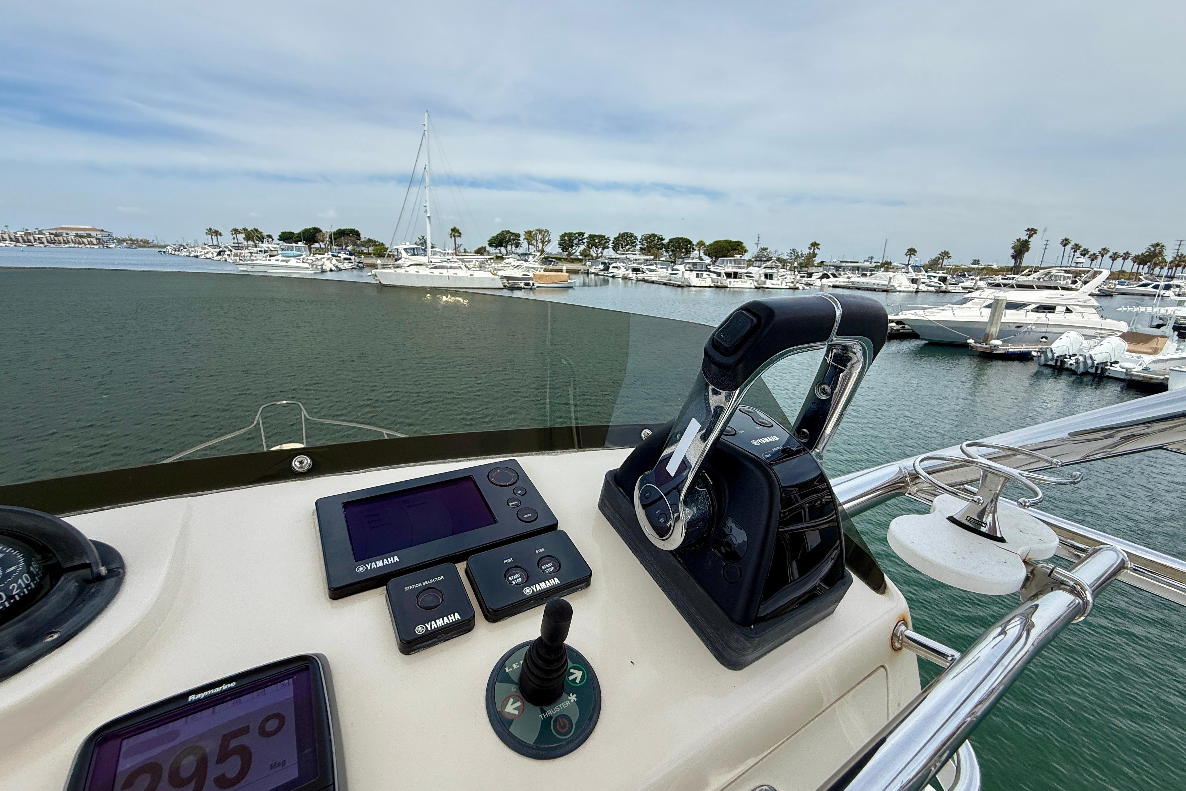 Helm of 2012 Pursuit OS 345 Offshore boat with Yamaha controls in marina.