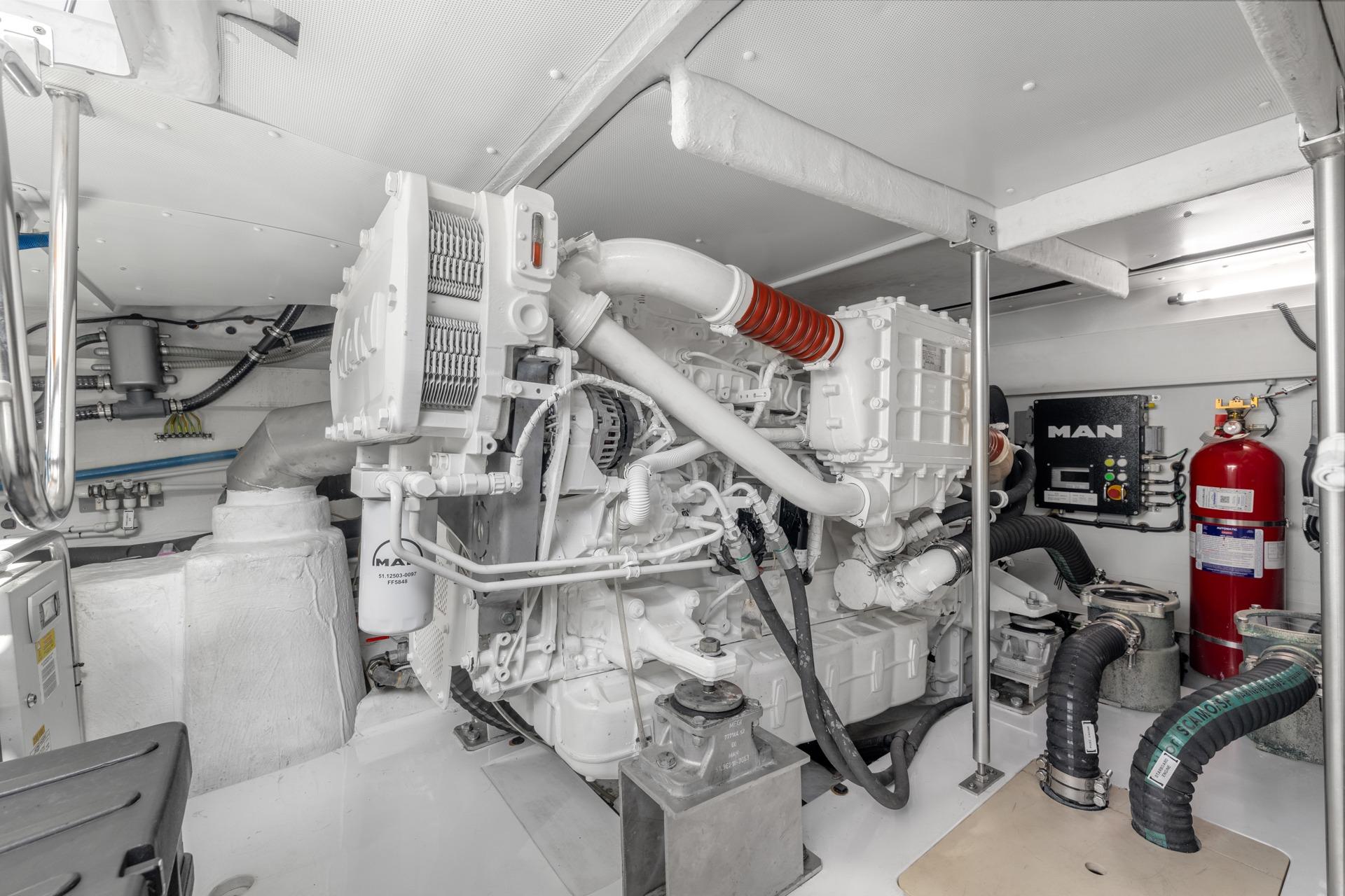 Engine room of a 2019 Azimut 55 yacht, featuring a MAN engine and safety equipment.