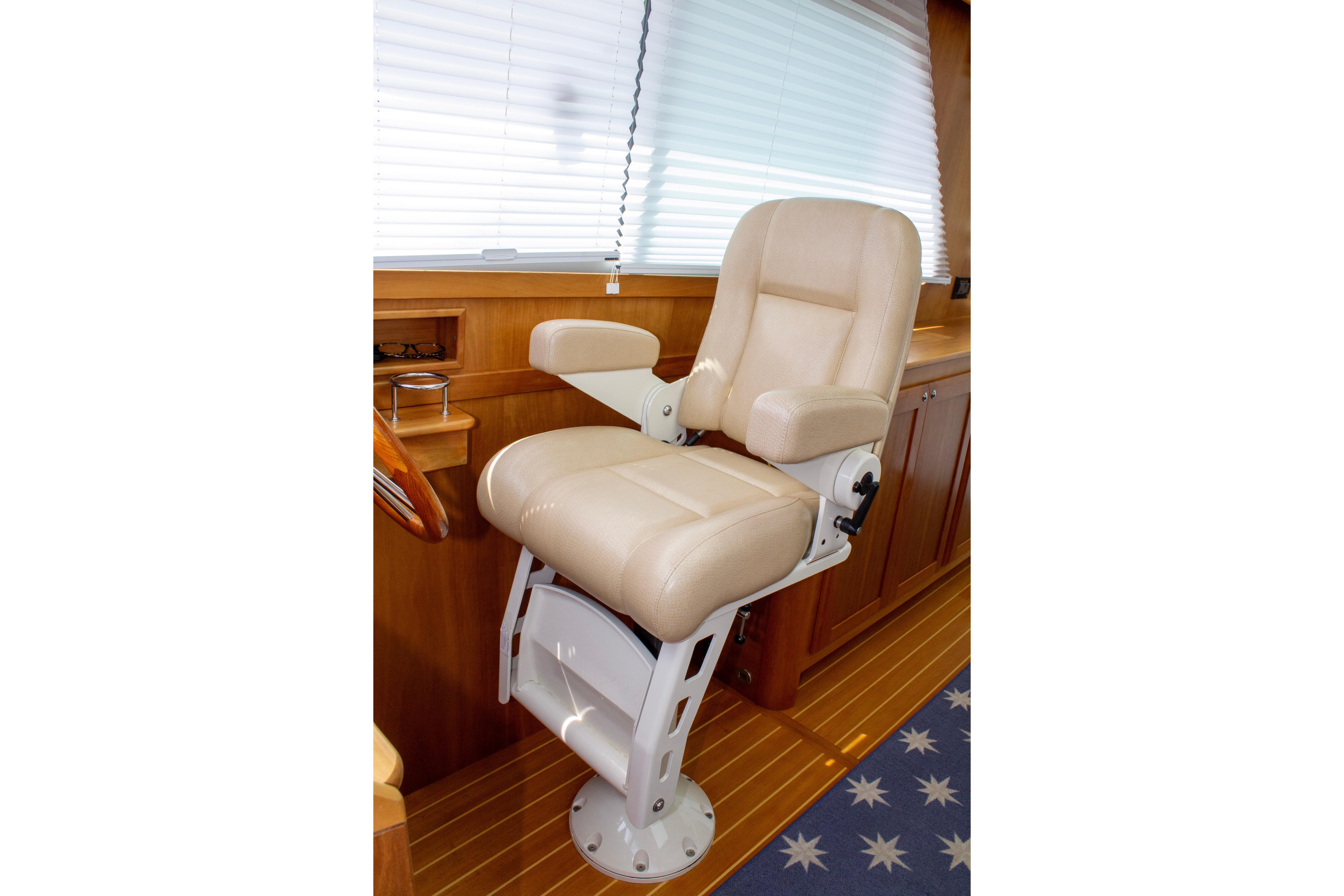 Captain's chair in 2013 Sabre 38 Salon Express yacht interior, featuring beige upholstery and wooden accents.