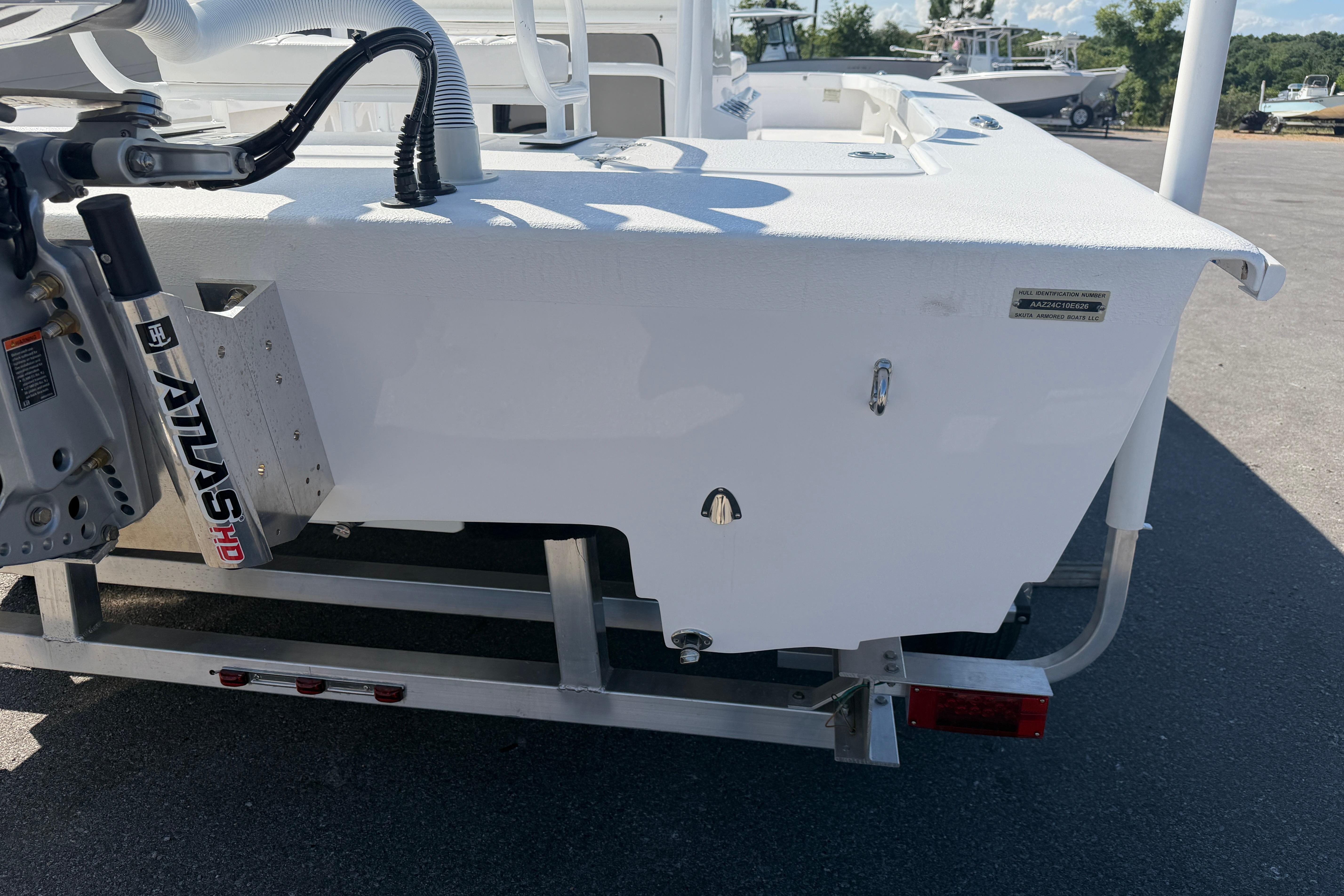 2026 Skuta 24 Cat boat on trailer, featuring Atlas hydraulic jack plate.