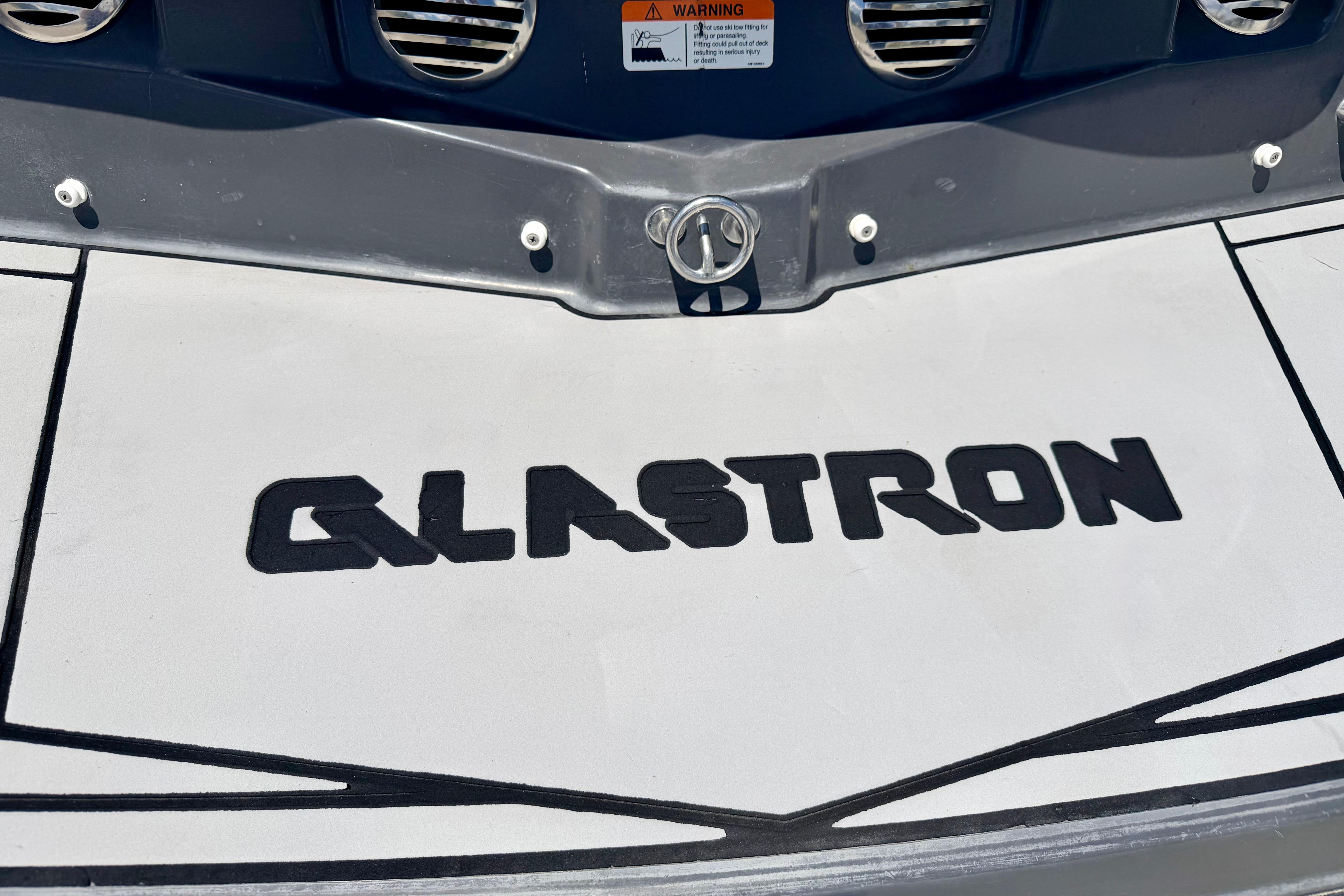 2018 Glastron GT 185 boat logo on deck, featuring bold black lettering.