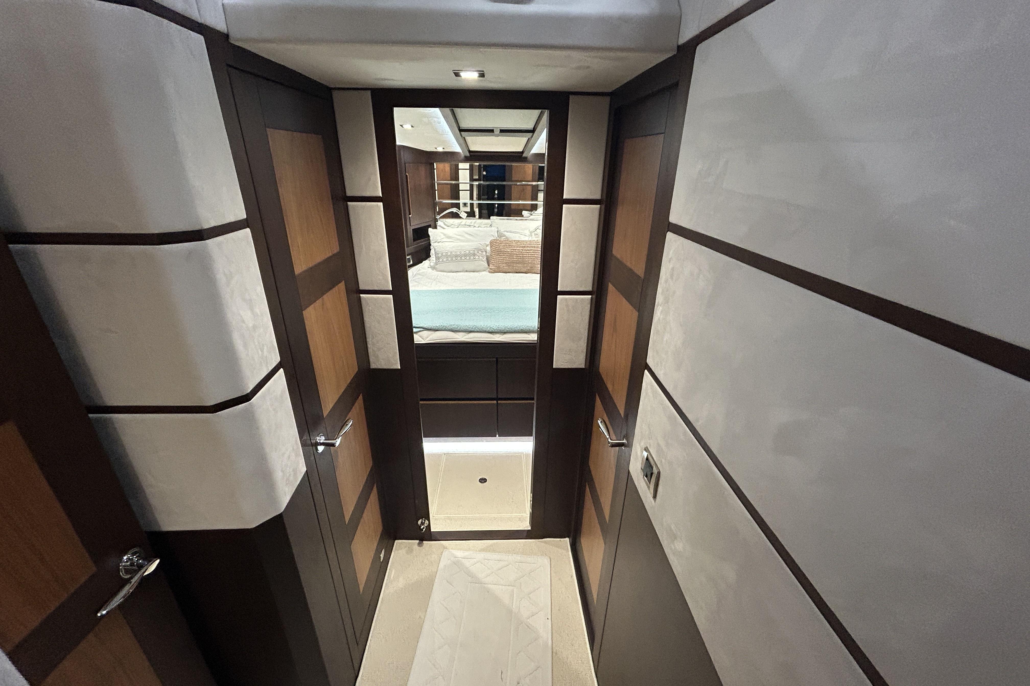 Luxurious interior hallway of 2018 Galeon 560 Sky yacht, featuring elegant wood paneling.