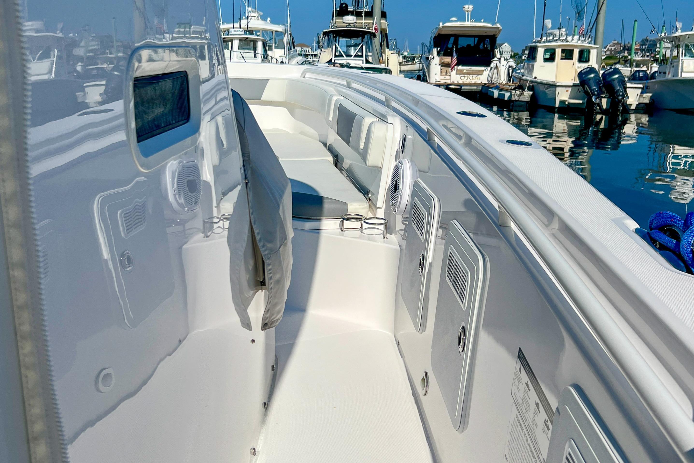 2017 Everglades 355 Center Console boat docked at marina, showcasing sleek design and storage compartments.