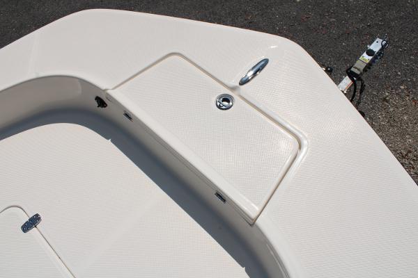 2023 Sundance DX20 boat deck with storage compartment and latch.
