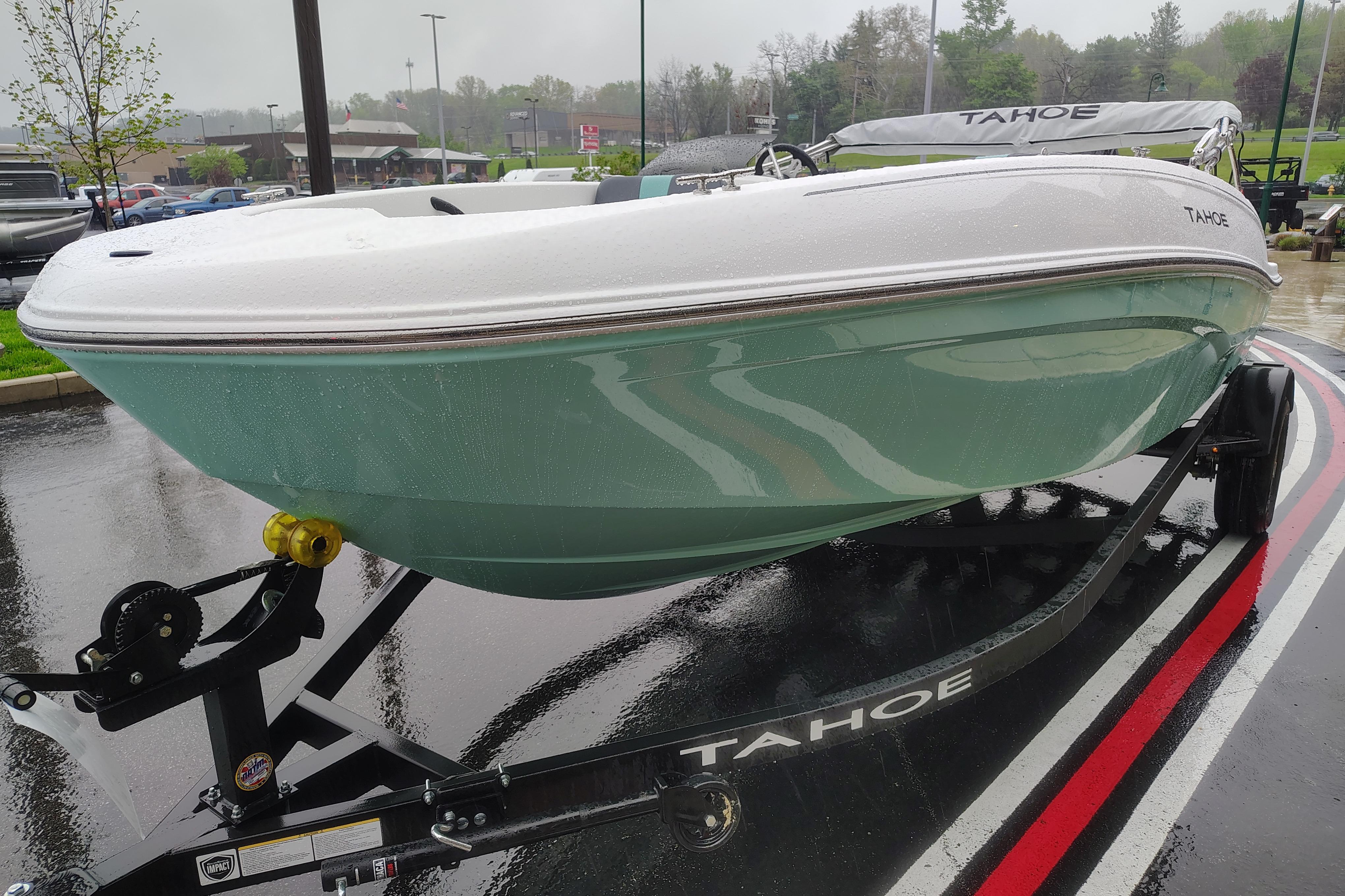 2026 Tahoe T18 boat on trailer in rainy parking lot.