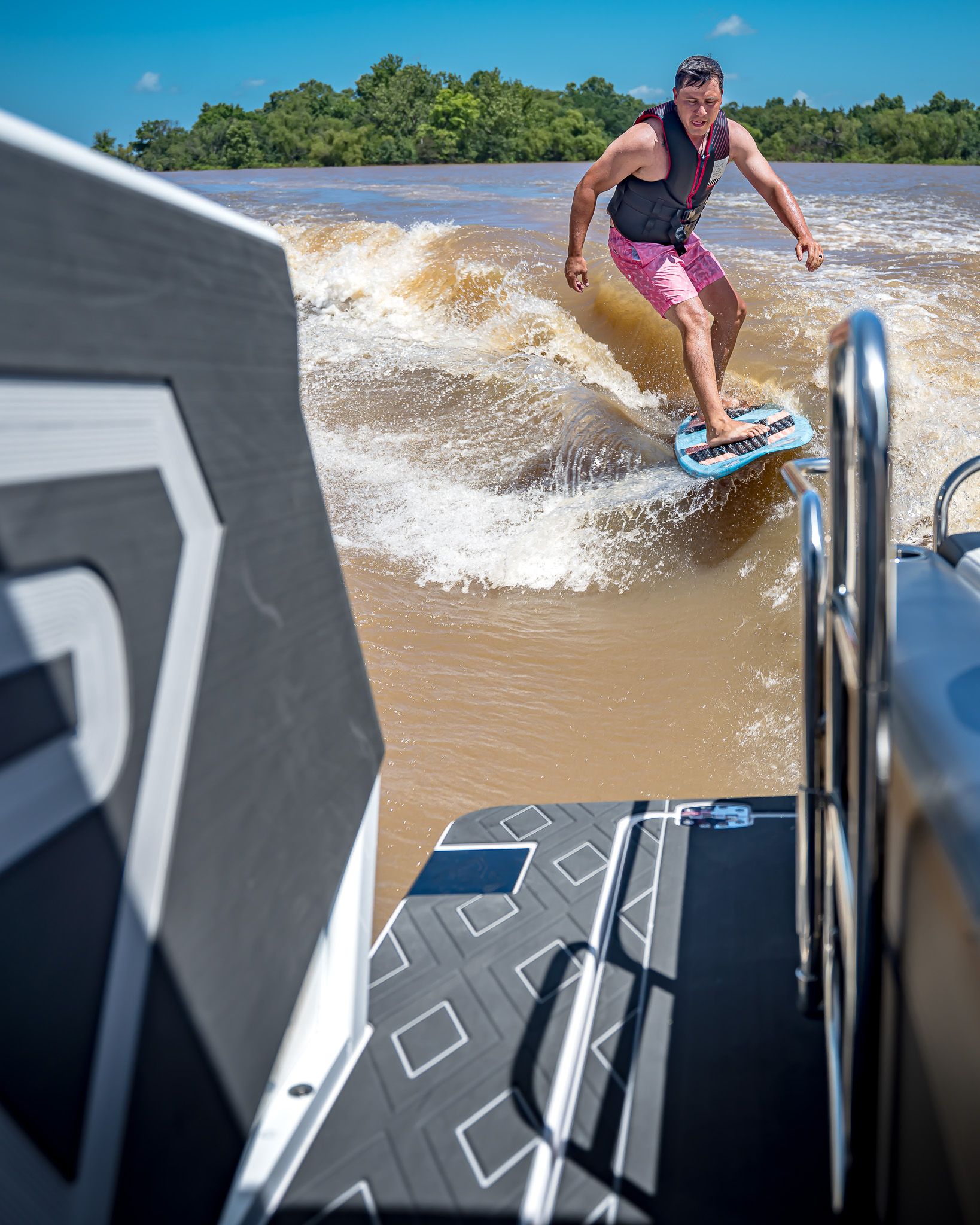 Man surfing behind Paradigm 266 SL SURF boat, 2025 model.