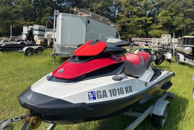 2010 Sea-Doo GTX 155 jet ski on trailer, parked on grass.