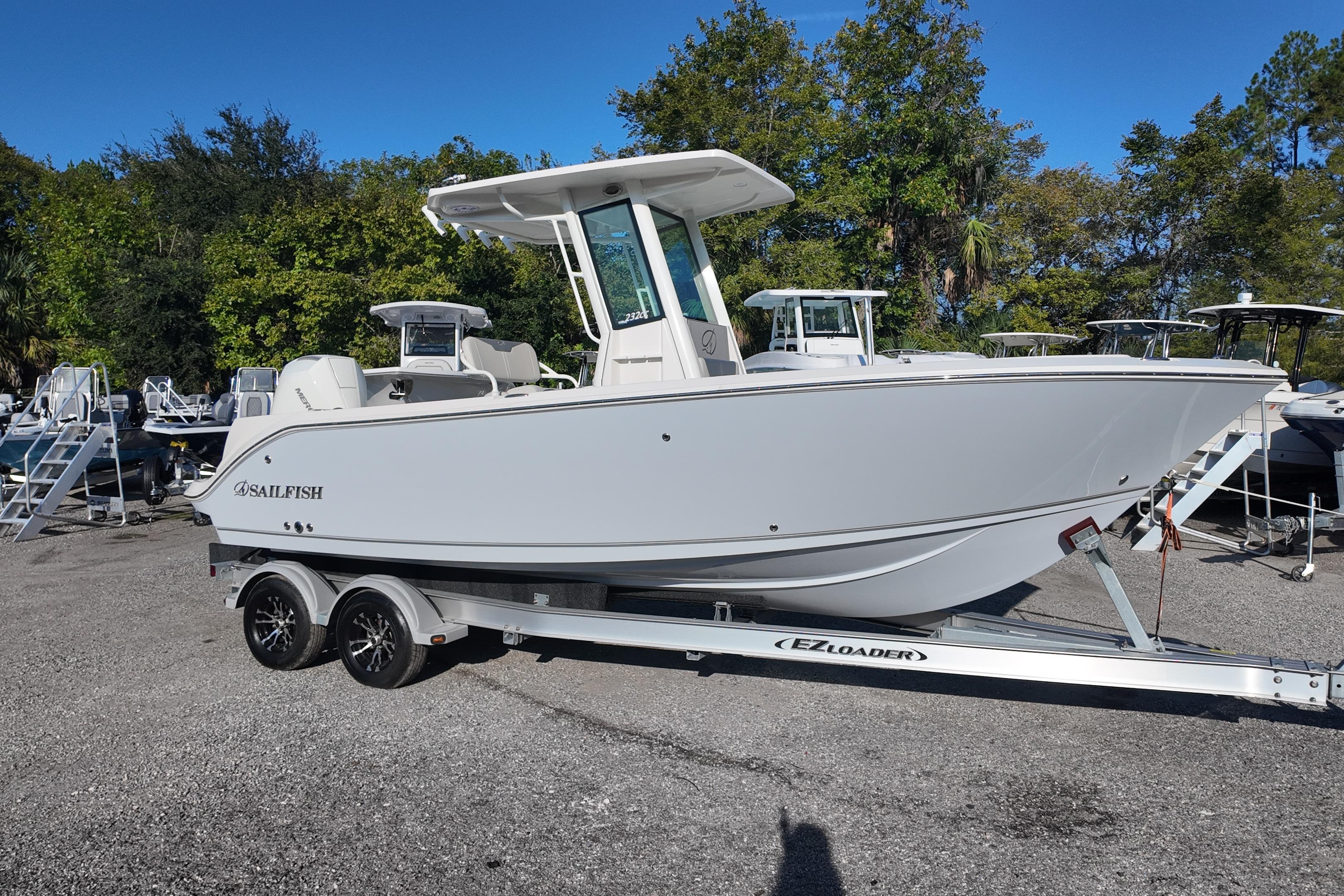 2026 Sailfish 232 CC boat on trailer, parked outdoors with trees in background.