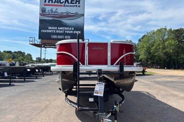 2026 Sun Tracker Party Barge 20 DLX pontoon boat on trailer at dealership.