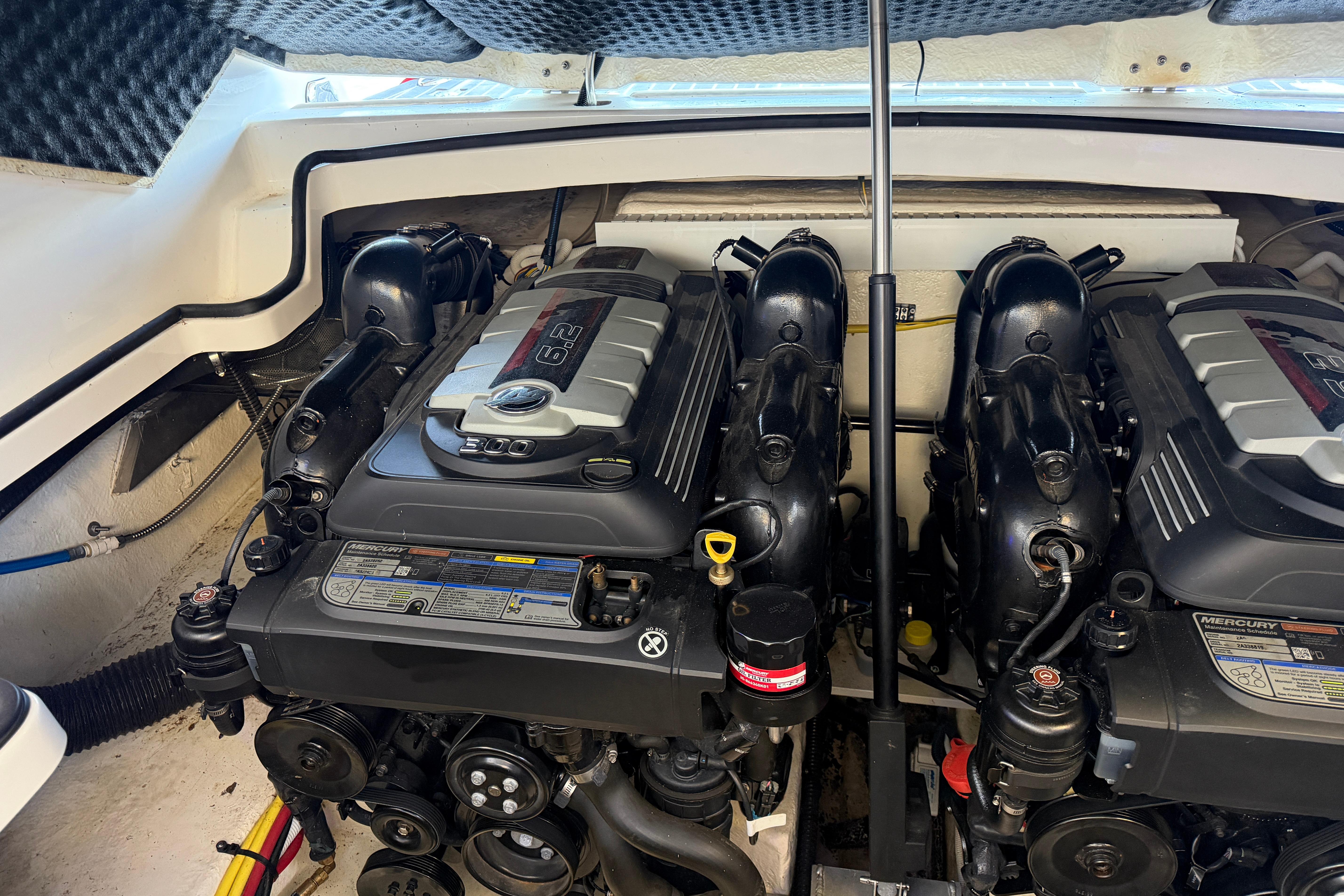 Engine compartment of a 2018 Chaparral 347 SSX boat, featuring dual Mercury engines.