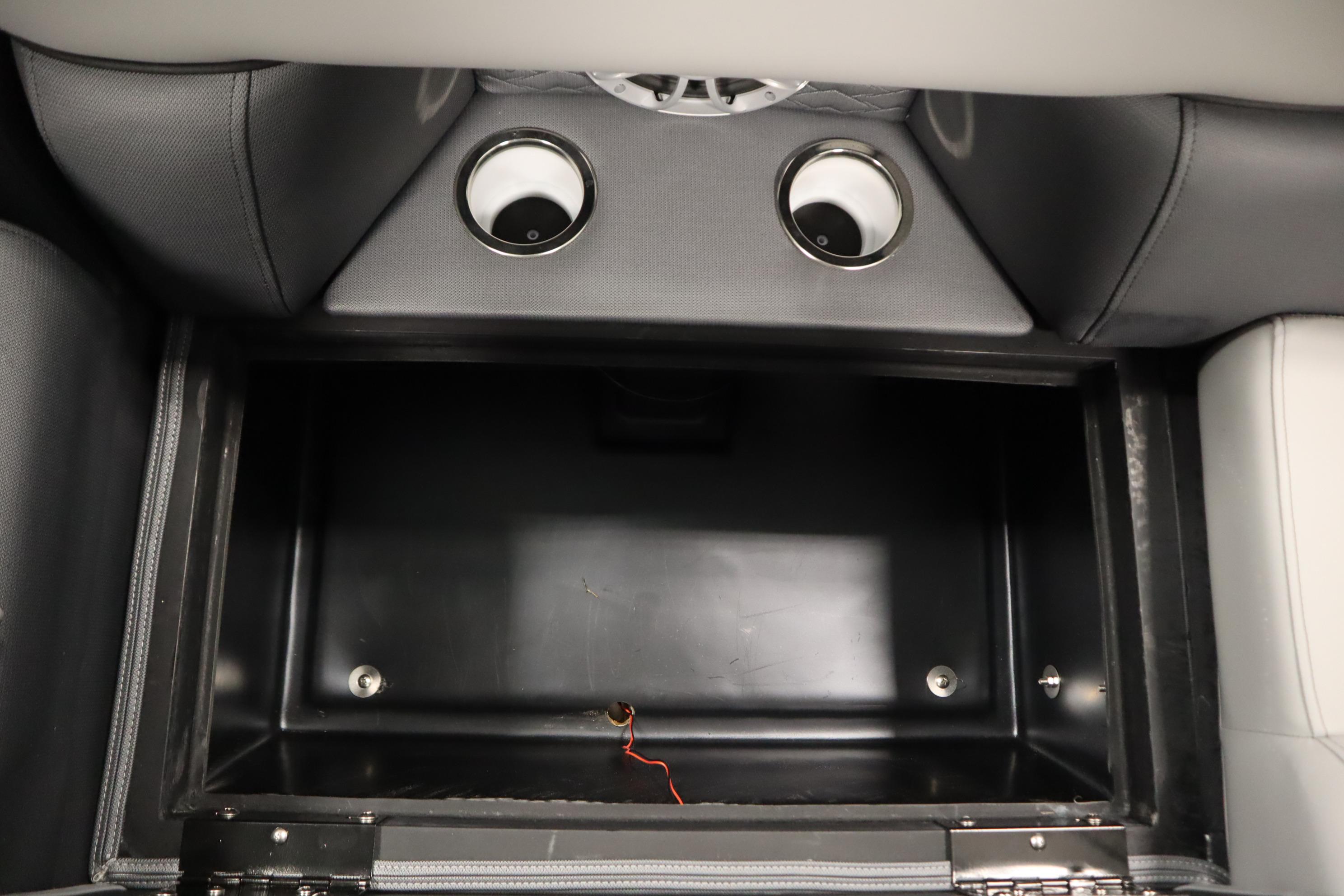 Storage compartment in 2025 Bentley Pontoons Elite 253 Admiral Tri-toon with cup holders.