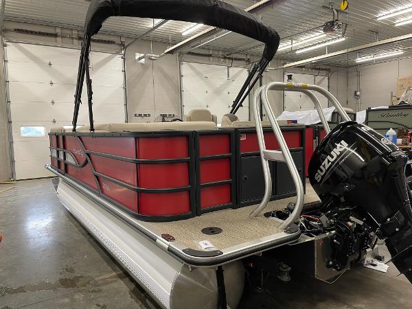 2025 Bentley Pontoons 200 Fish-N-Cruise in a garage, featuring a Suzuki outboard motor.
