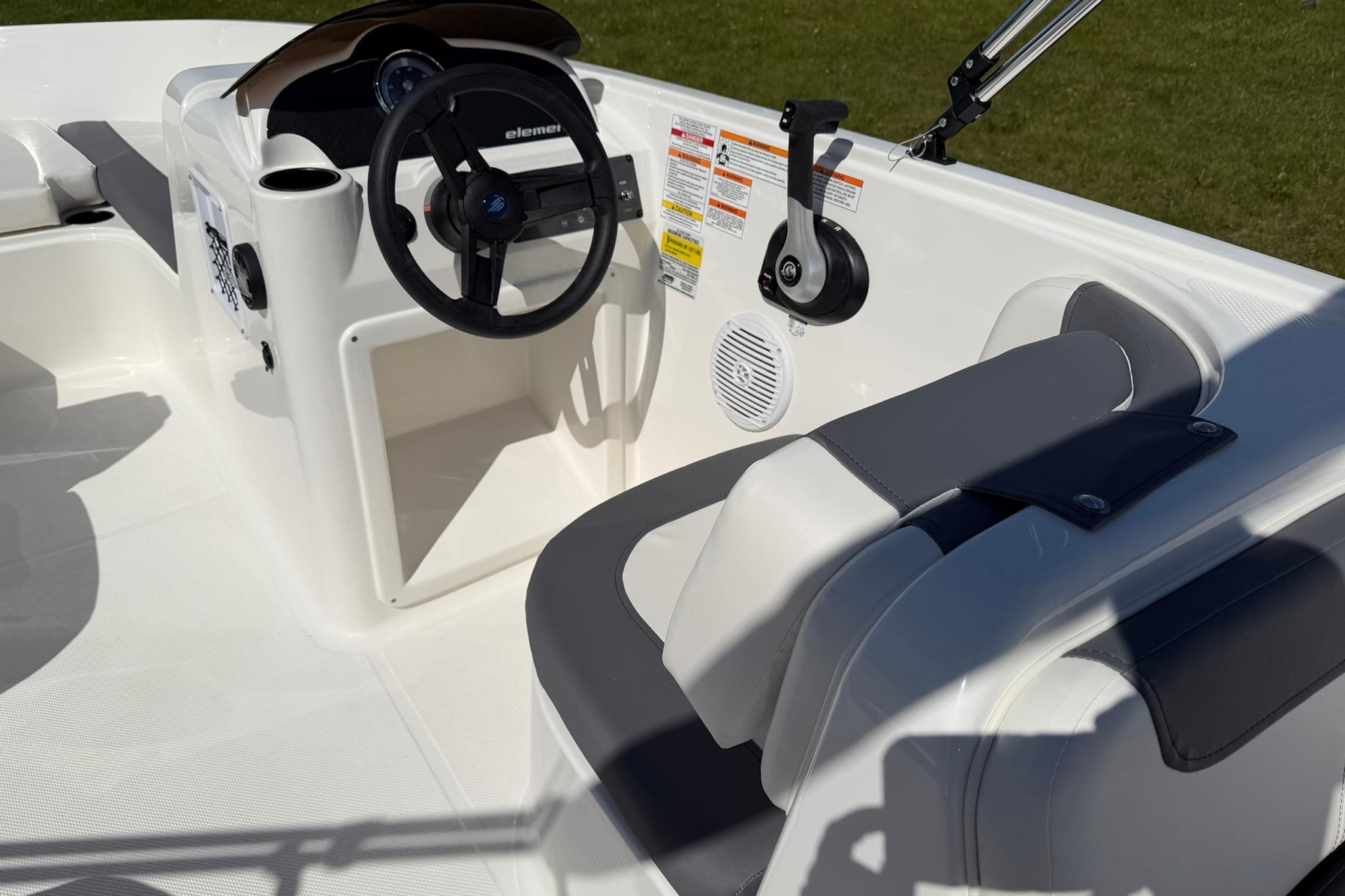 2026 Bayliner Element E18 boat interior with steering wheel and seating.