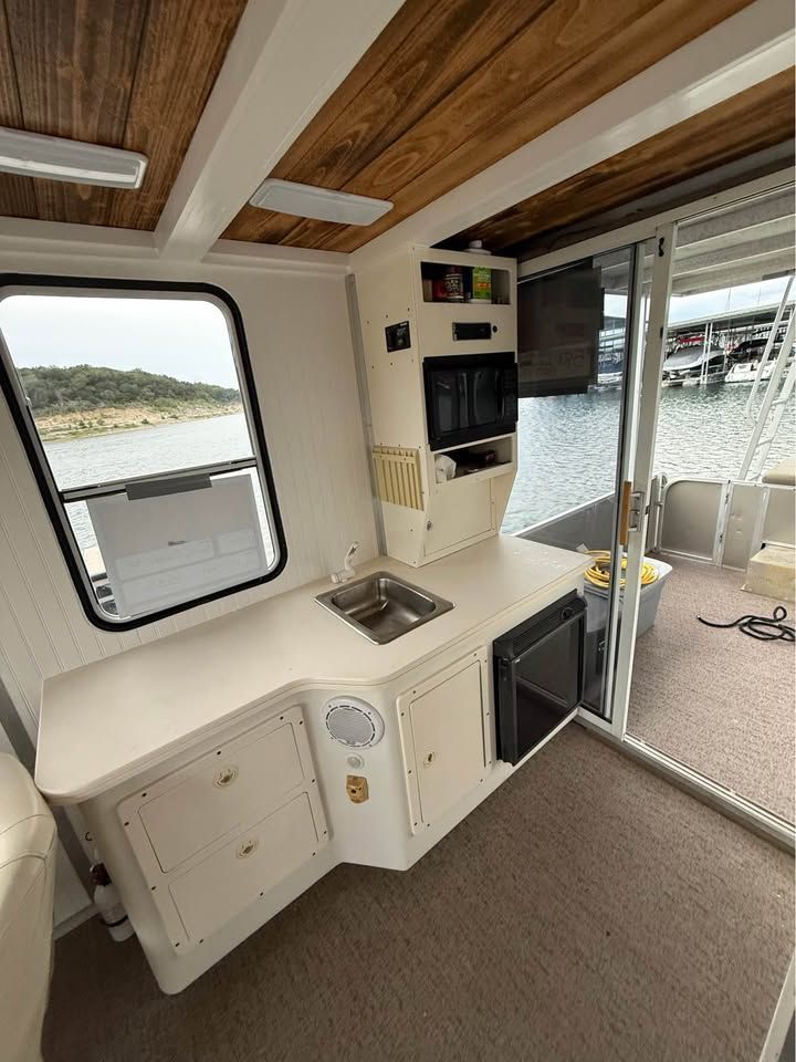 Interior of a 2008 Sun Tracker Party Cruiser with kitchenette.