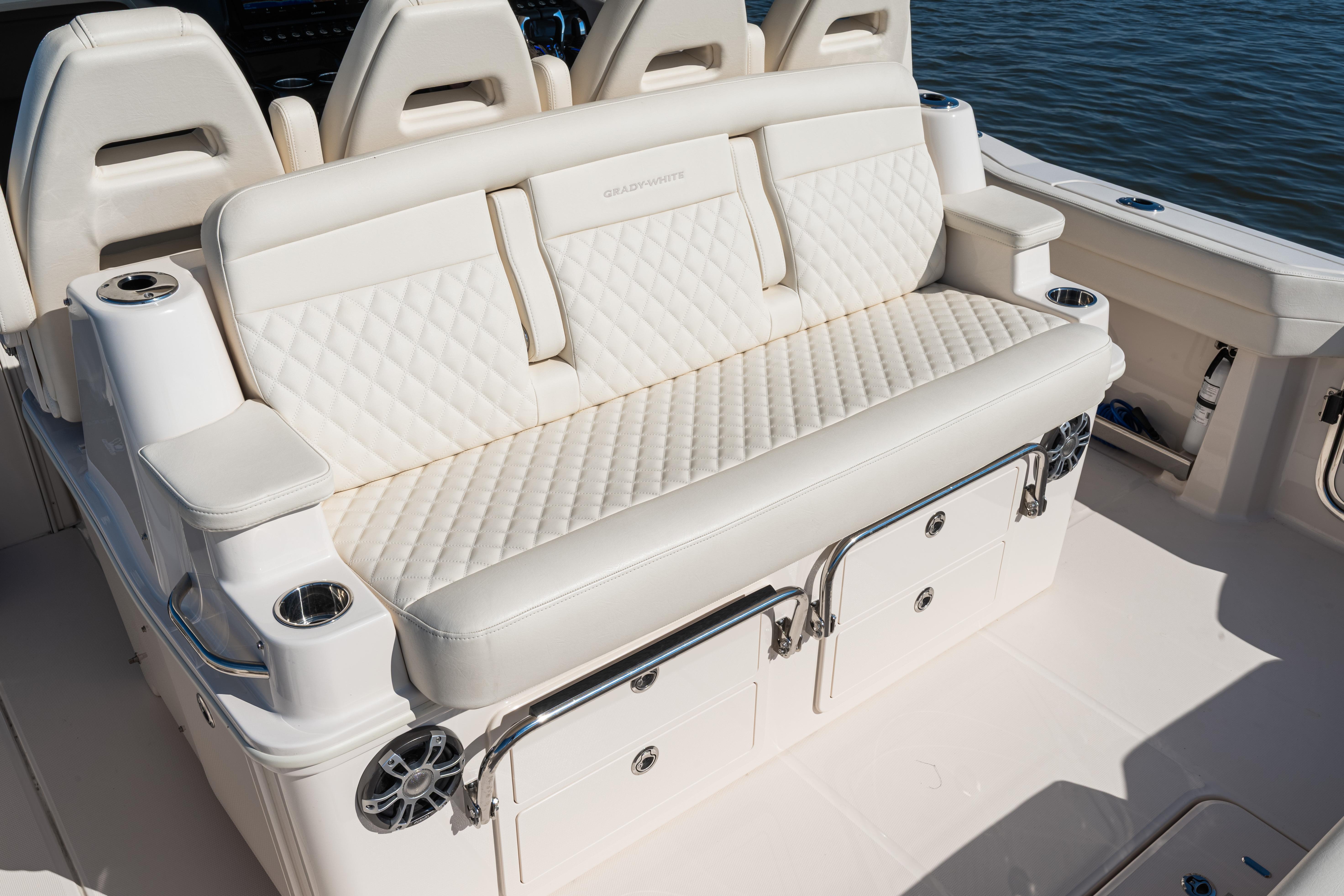 Luxurious seating on 2025 Grady-White Canyon 386 boat, featuring quilted upholstery and cup holders.