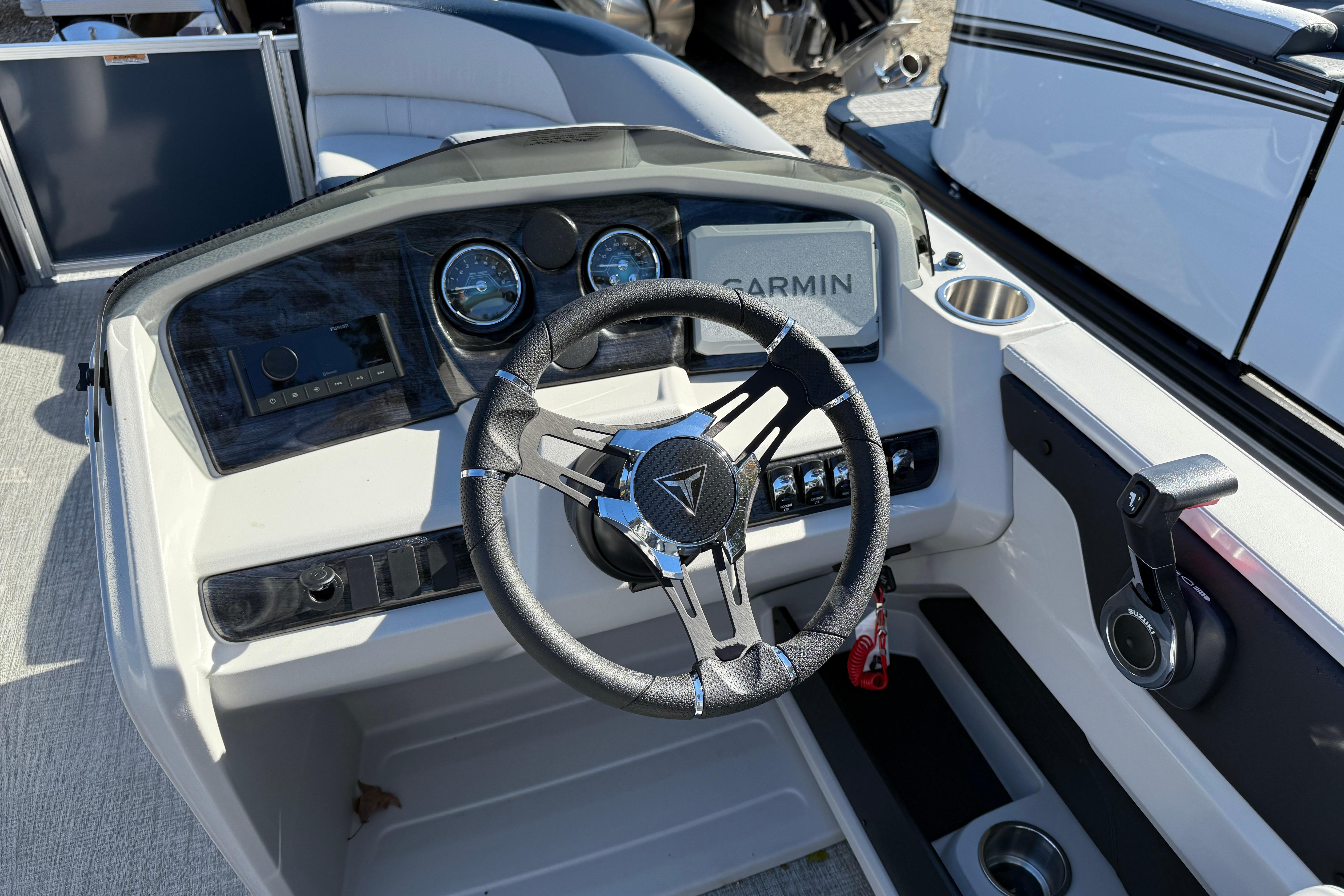 2026 Tahoe Pontoon LTZ Quad Lounger dashboard with steering wheel and Garmin display.