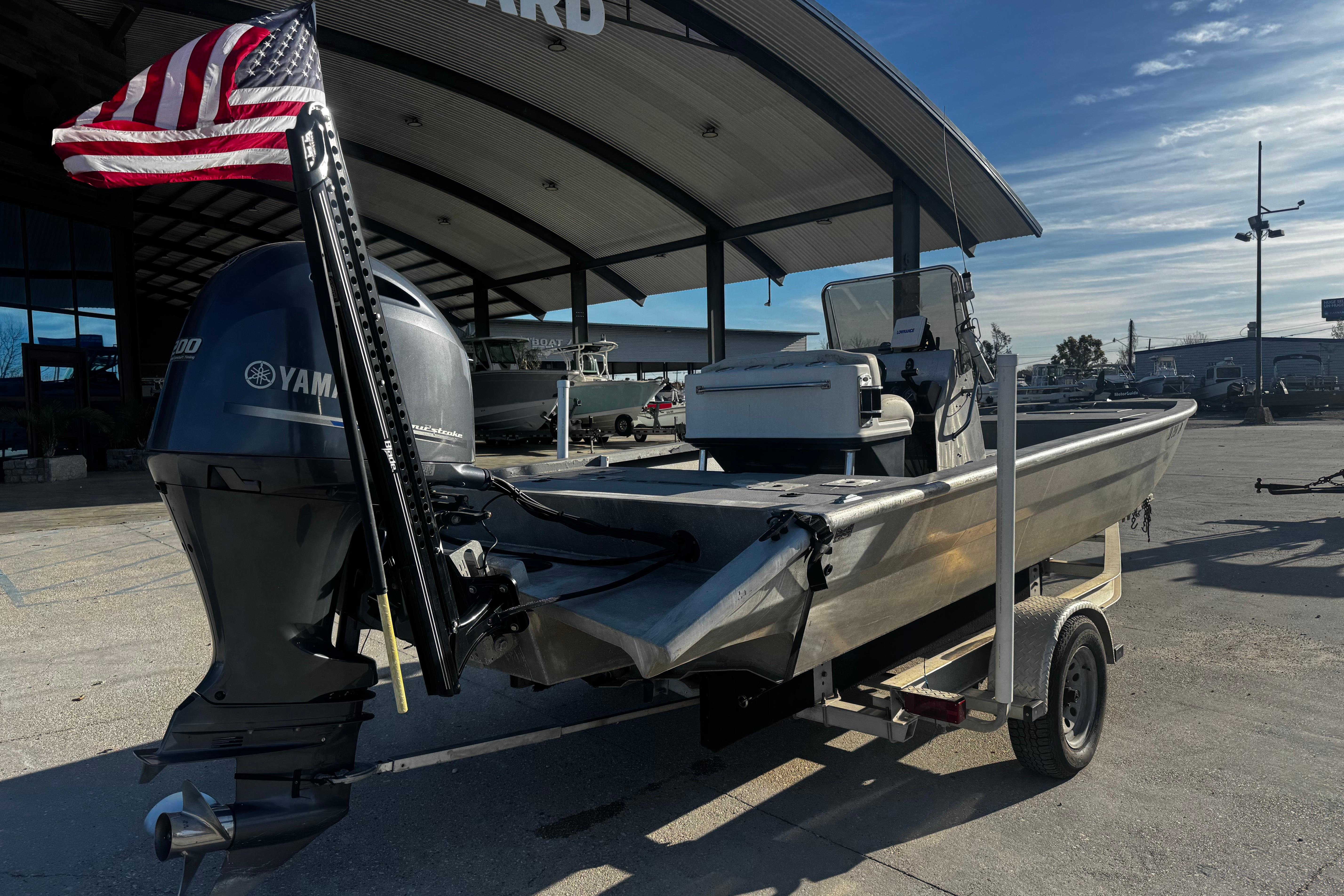 Custom Charles Leonard 21 boat, 2004 model, with Yamaha engine and American flag, on trailer.