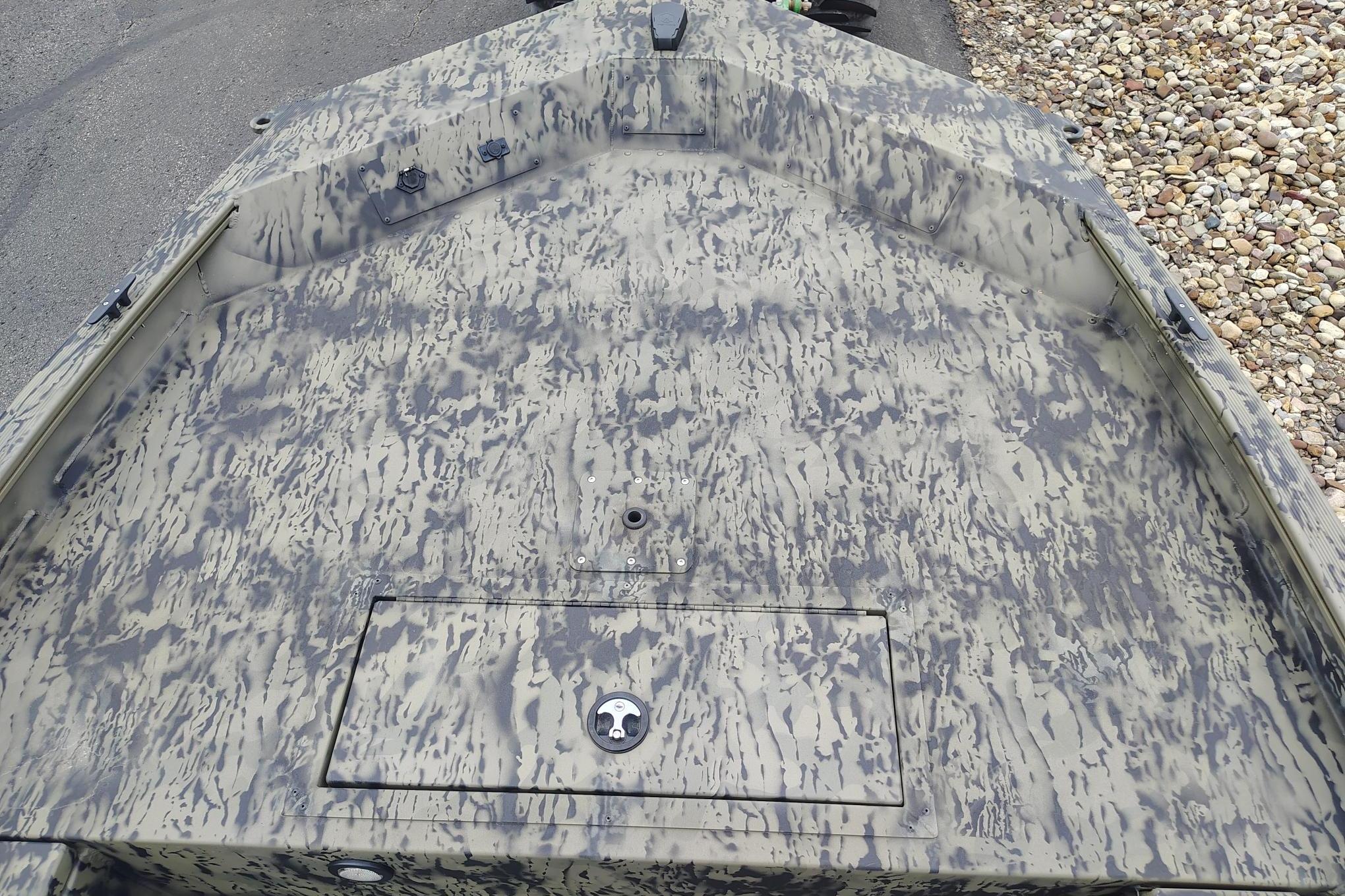 2026 Tracker Grizzly 1654 T Sportsman boat with camouflage pattern on deck.