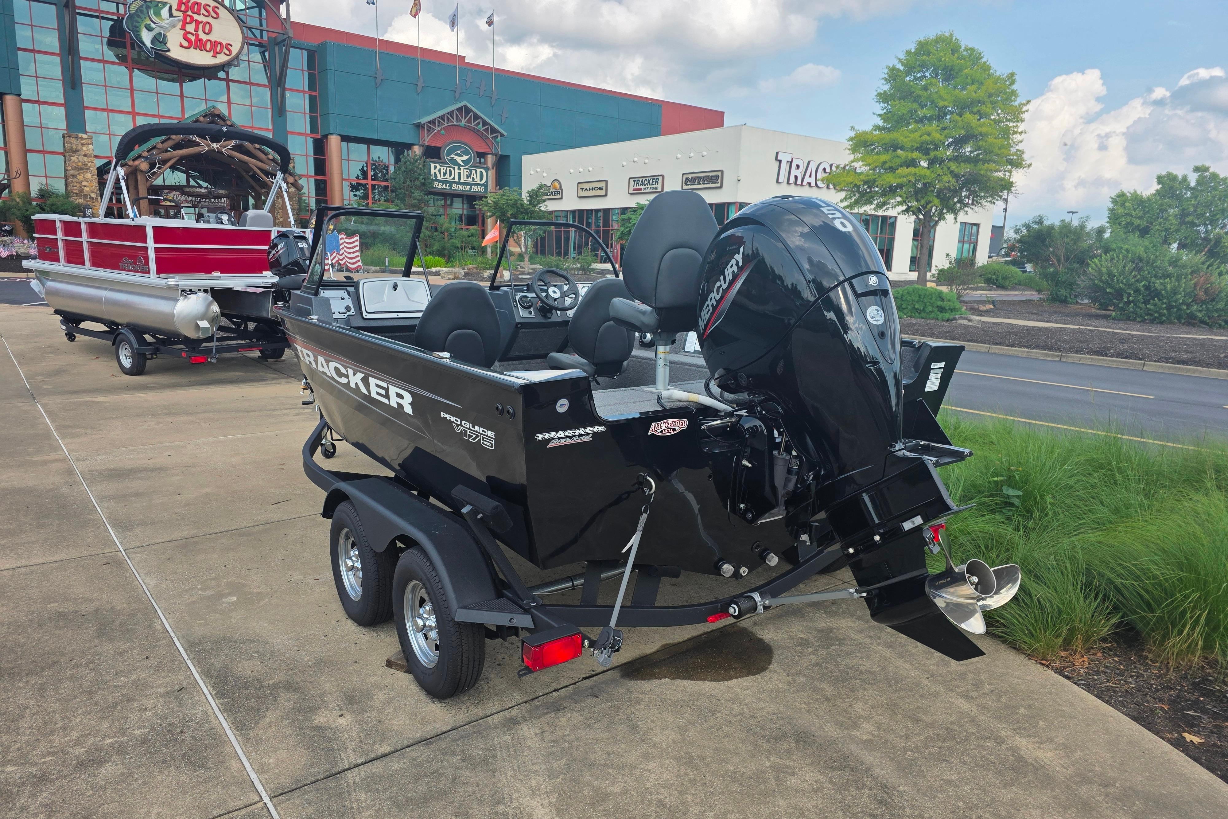 2026 Tracker Pro Guide V-175 Combo boat on trailer outside Bass Pro Shops.