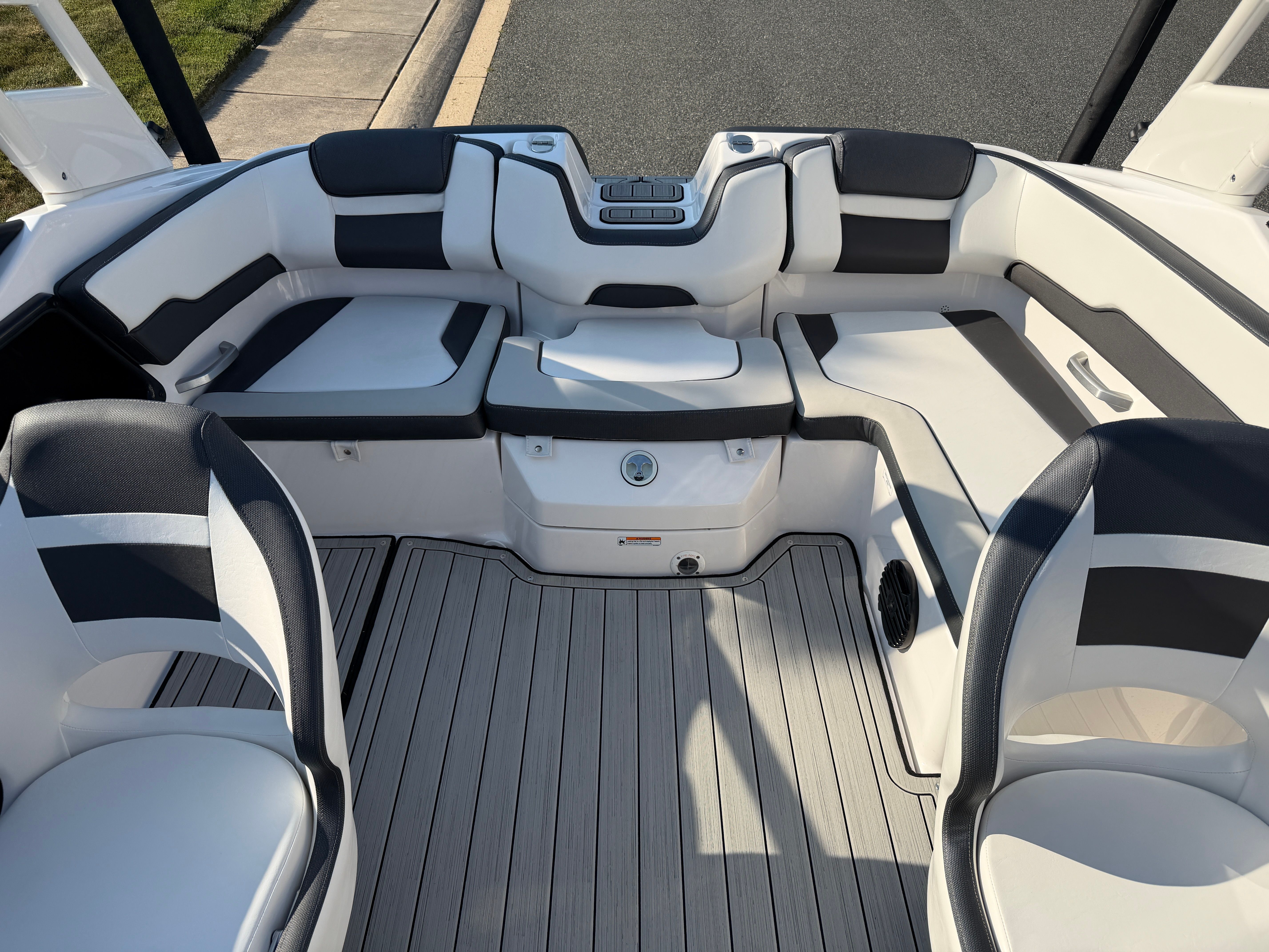 The image shows the cockpit of a 2023 Yamaha 195S boat with stylish seating and modern design.
