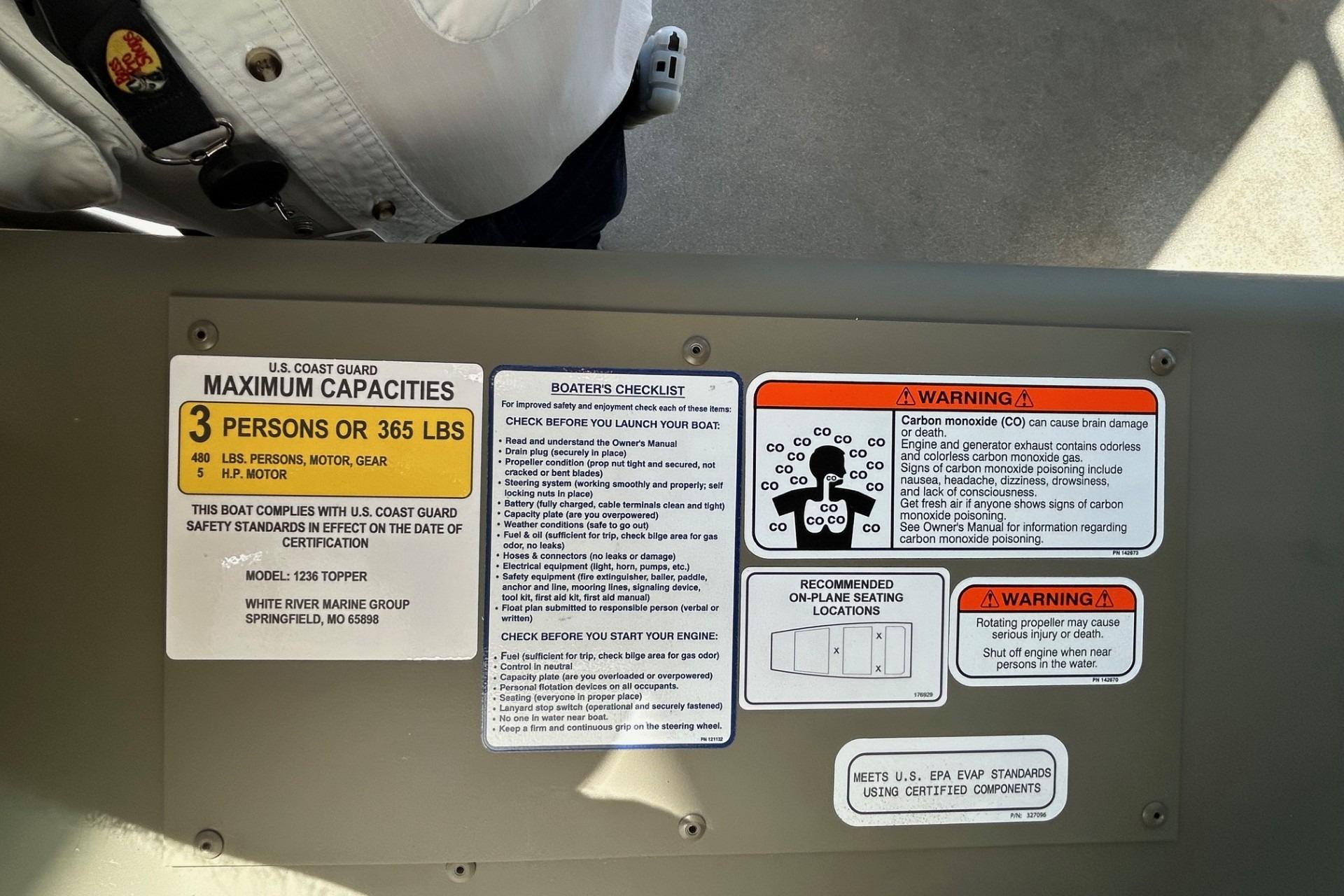 Safety labels and warnings on a 2026 Tracker Grizzly 14 Jon boat.