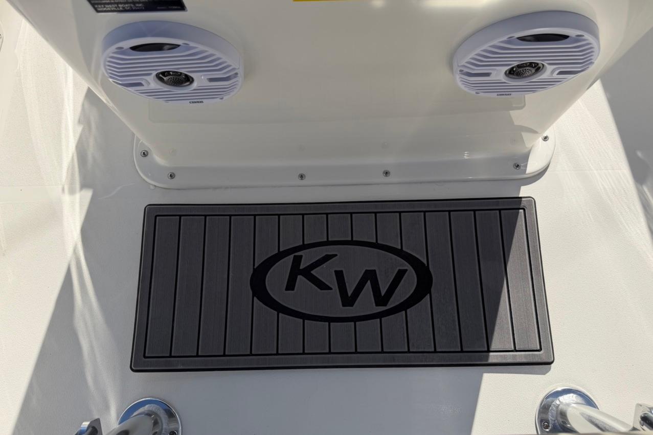 2026 Key West 1720 Center Console boat deck with KW logo mat and speakers.