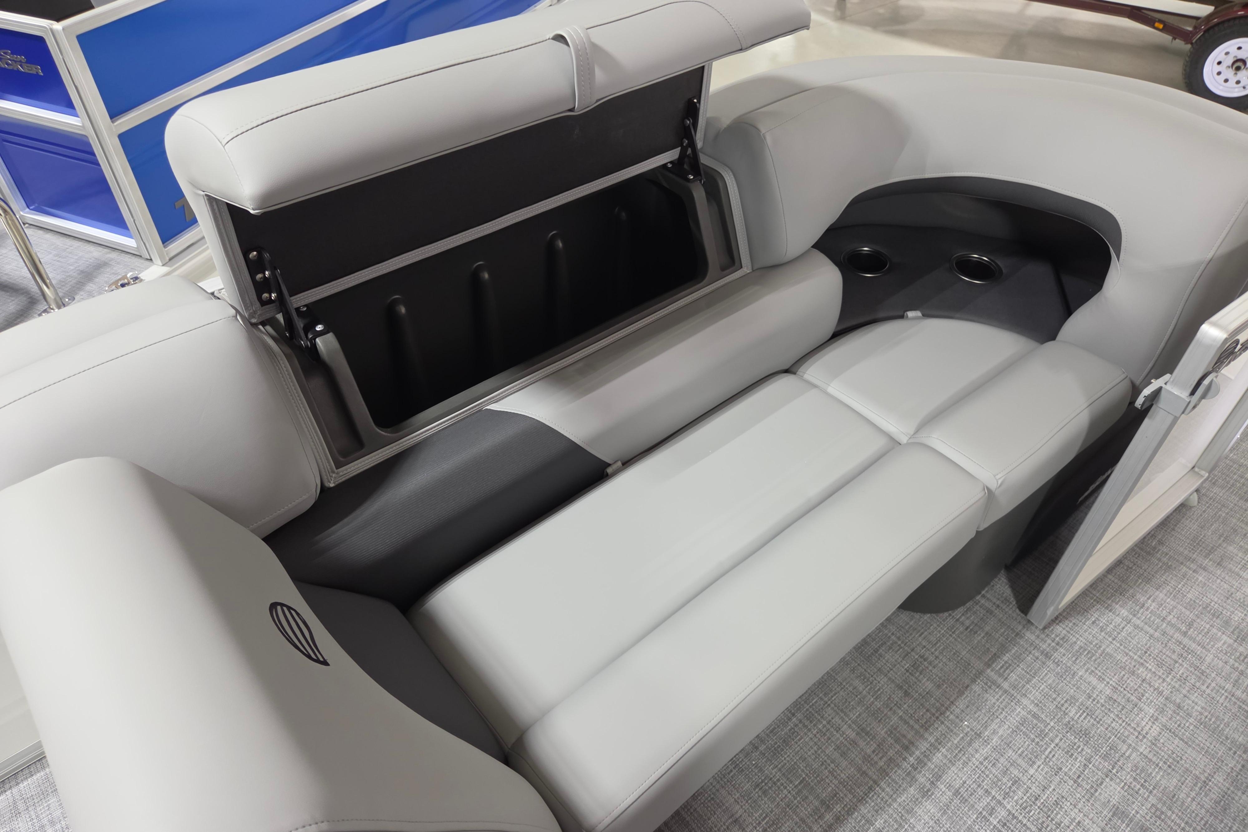 2026 Sun Tracker Party Barge 20 DLX interior seating with storage and cup holders.
