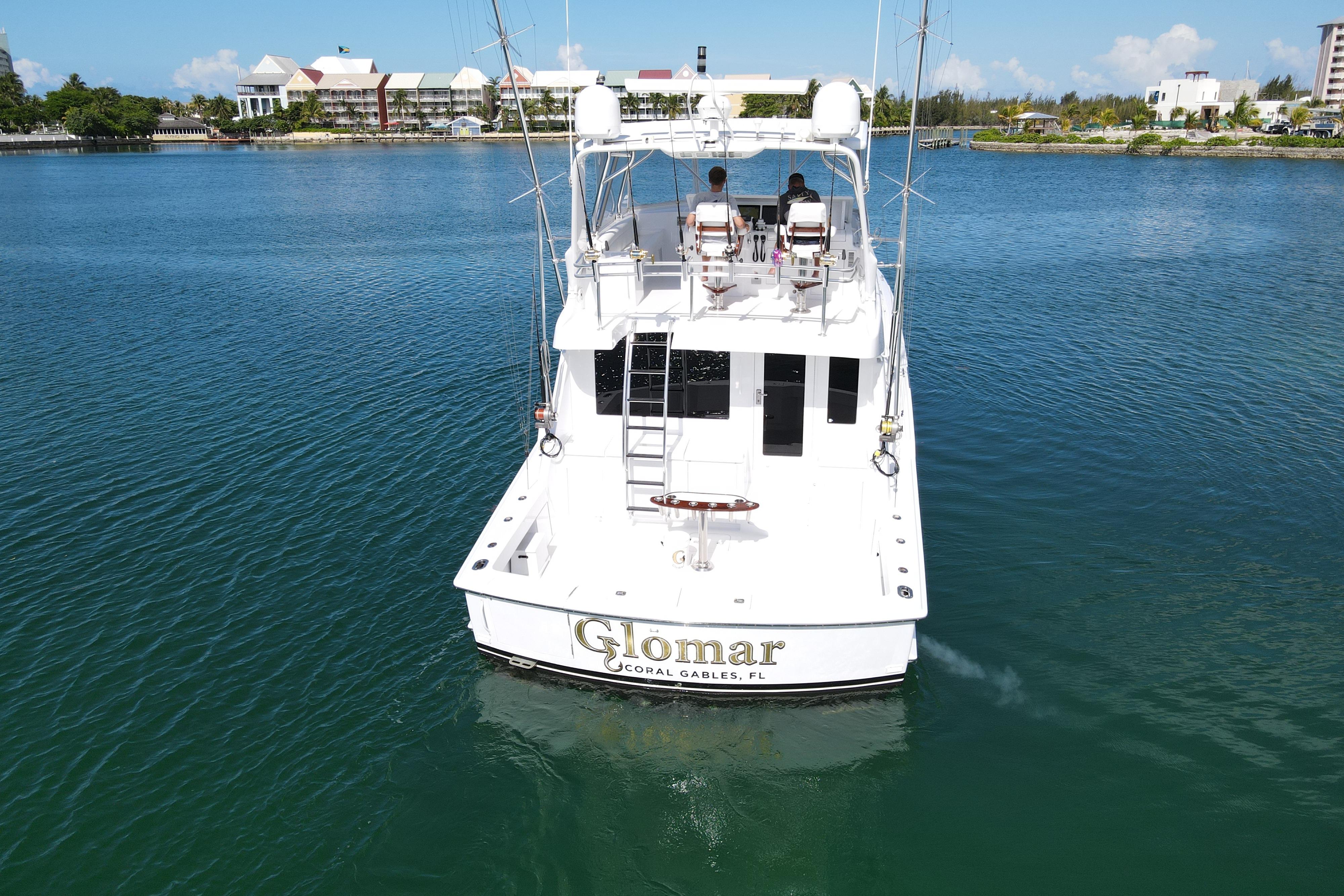 2004 Hatteras 60 Convertible yacht on calm water, rear view.