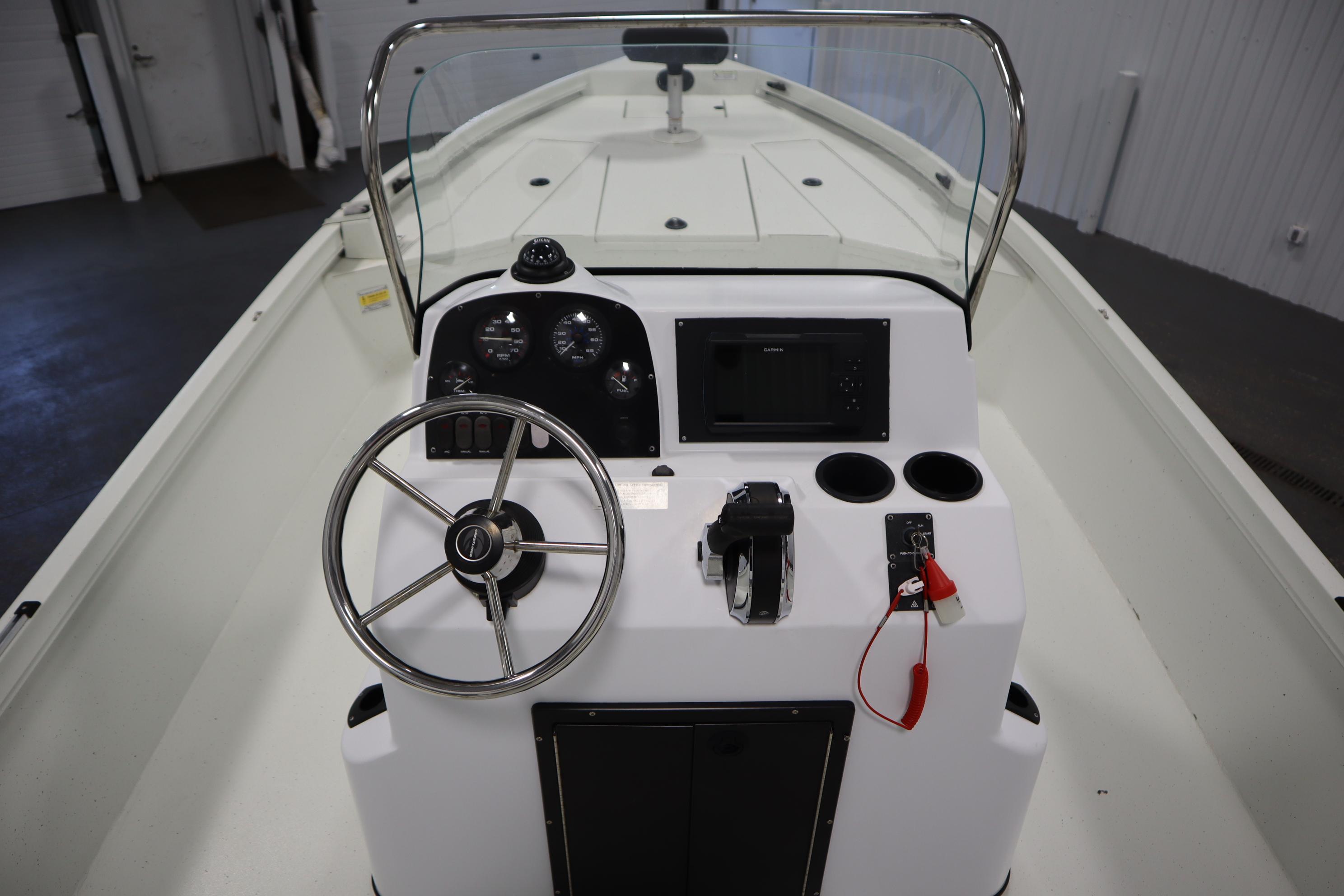 2022 Crestliner 2200 CC boat console with steering wheel and controls.