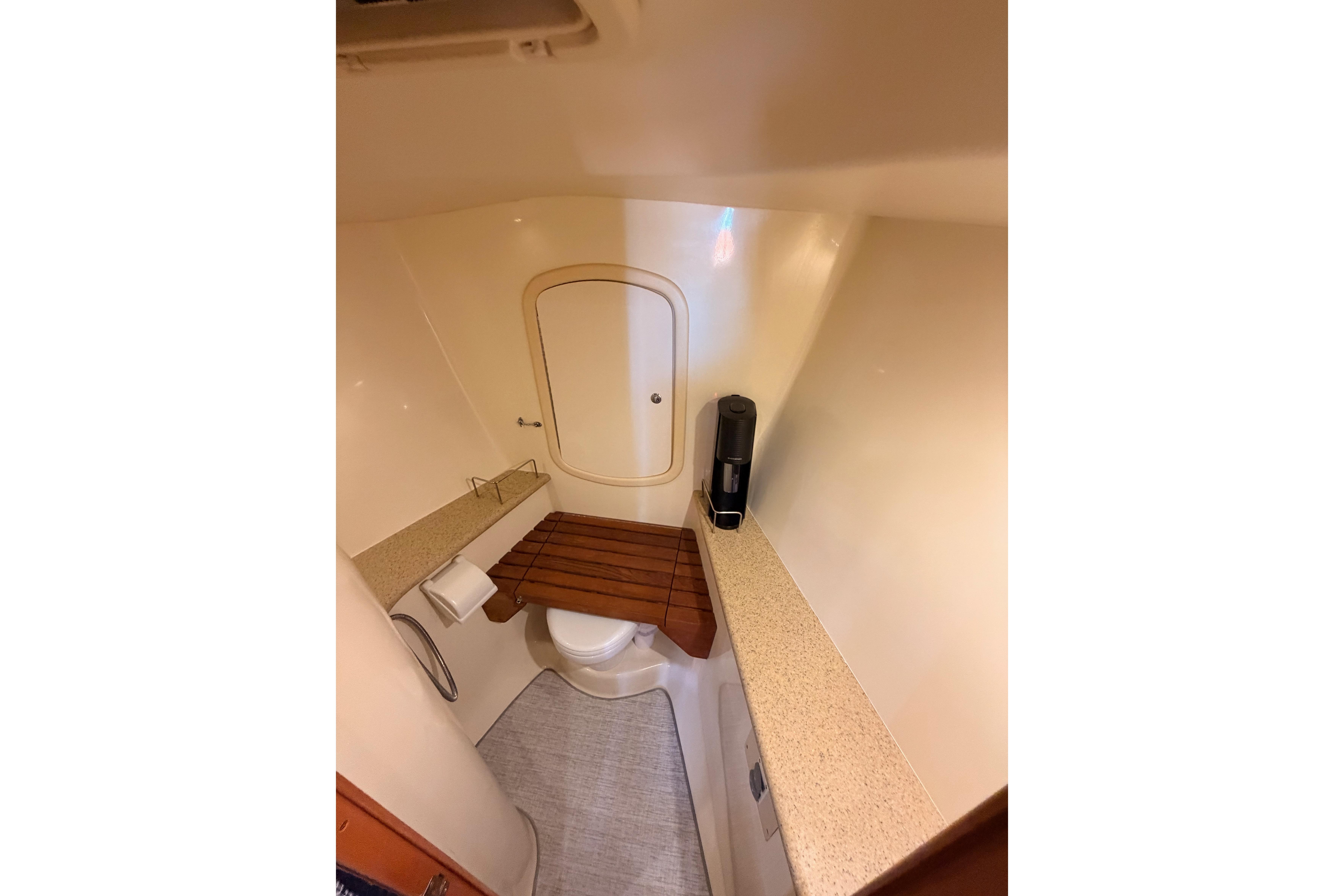 Bathroom interior of 2008 Hunter 45 Deck Salon yacht, featuring compact design and wooden accents.